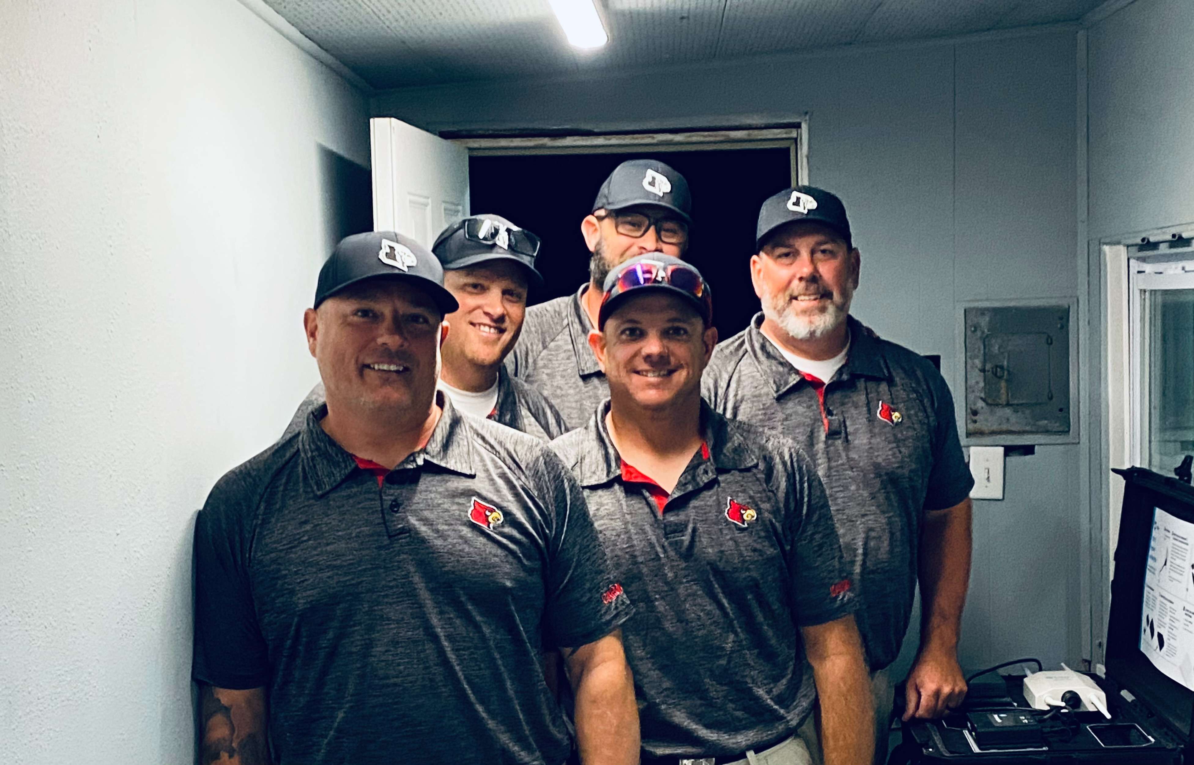 Hoisington High School football coaches Rob England, Matt Koelsch, Eric Steiner, Zach Baird and Kyle Haxton pose for a picture Friday, Sept. 27, 2024. Baird earned his 100th win as Hoisington head coach.