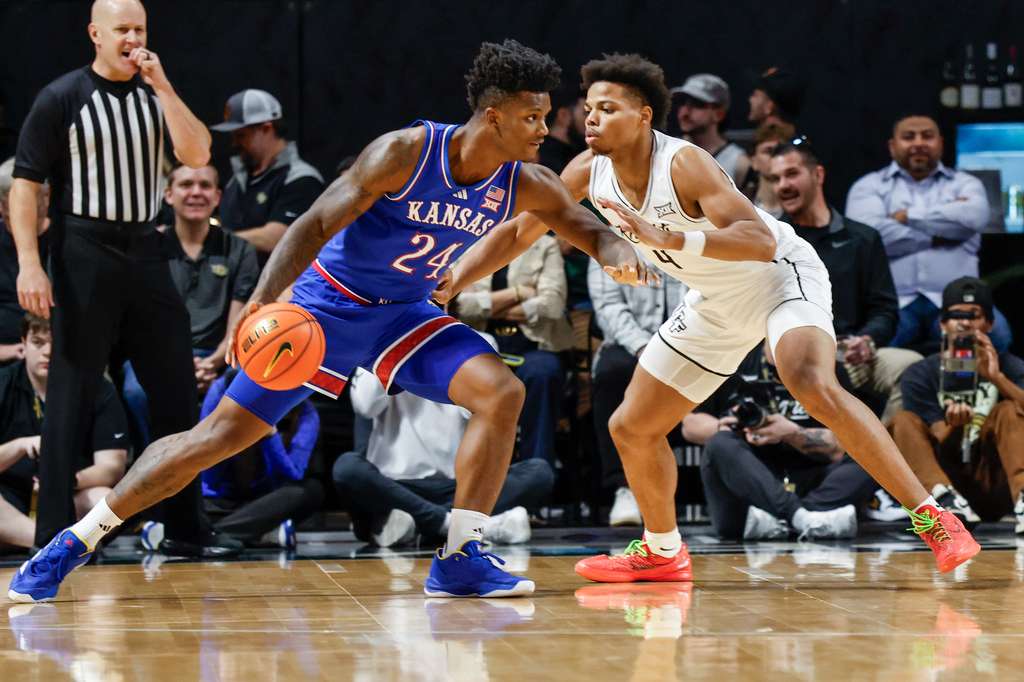 Kansas forward KJ Adams Jr. (24) drives against Central Florida guard Keyshawn Hall (4) during the first half of an NCAA college basketball game, Sunday, Jan. 5, 2025, in Orlando, Fla. (AP Photo/Kevin Kolczynski)