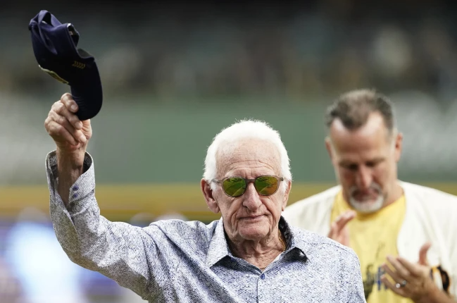 FILE - Milwaukee Brewers radio announcer Bob Uecker tips his cap before a baseball game between the Milwaukee Brewers and the Miami Marlins,, July 28, 2024, in Milwaukee. (AP Photo/Aaron Gash)