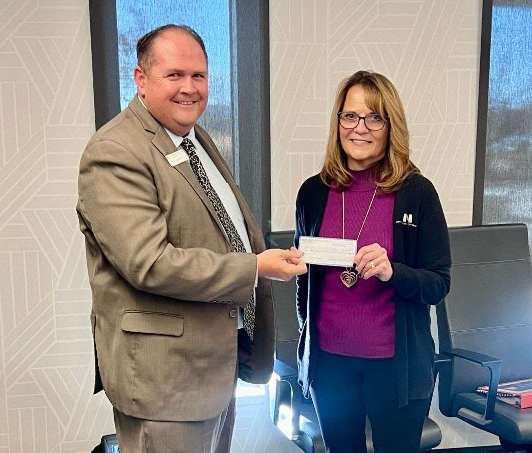 WNCC President Greg Dart accepts a check for $15,000 from NPPD Account Manager Melody Baily. The funds were raised from the 33rd annual Wells Fargo Nebraska Open in the fall.