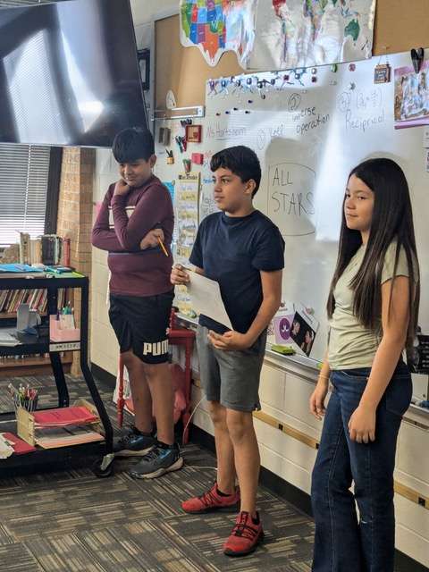 From left to right: Jose Suarez, Jacob Rodriguez and Kendra Talamantes present information about their futuristic invention – an electronic notepad that teleports people by typing in an address. The Riley School sixth-graders participate in All Stars.