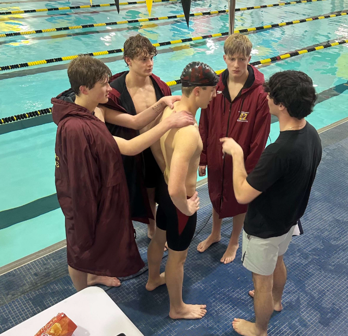 Team unity is a huge element of Coach Tyler Stein’s philosophy. As he talks with Cedric Durr after a race, teammates Karsen Flaska, Chase Zadina and Noah Schaeffer congratulate their teammate. (Photo by Diane Gasper-O’Brien/Special to Hays Post)