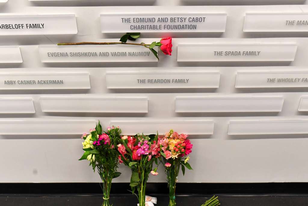A rose rests near the names of figure skating coaches Evgenia Shishkova and Vadim Naumov on a commemorative wall Thursday, Jan. 30, 2025, at the Skating Club of Boston in Norwood, Mass. The two former world champions who were coaching at the historic Boston club were among the members of the skating community killed when an American Airlines flight collided with an Army helicopter Wednesday, Jan. 29, and crashed into the Potomac River. (AP Photo/Steven Senne)