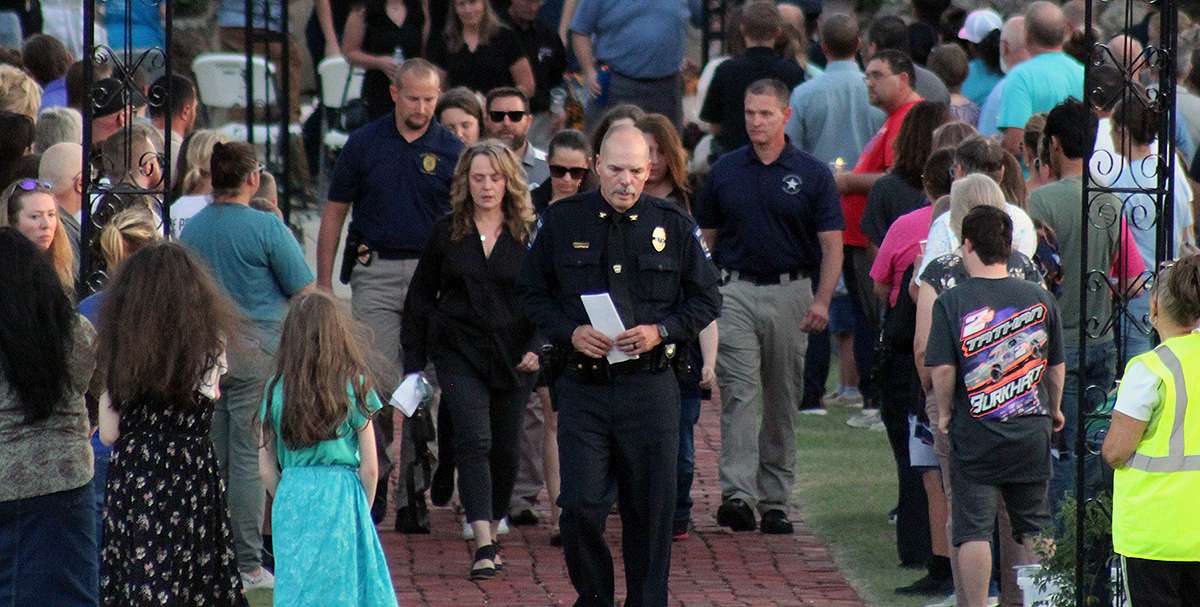 Hays Police Chief Don Scheibler exits the vigil for Hays Police Sgt. Scott Heimann followed by members of the family. Photo by Cristina Janney/Hays Post