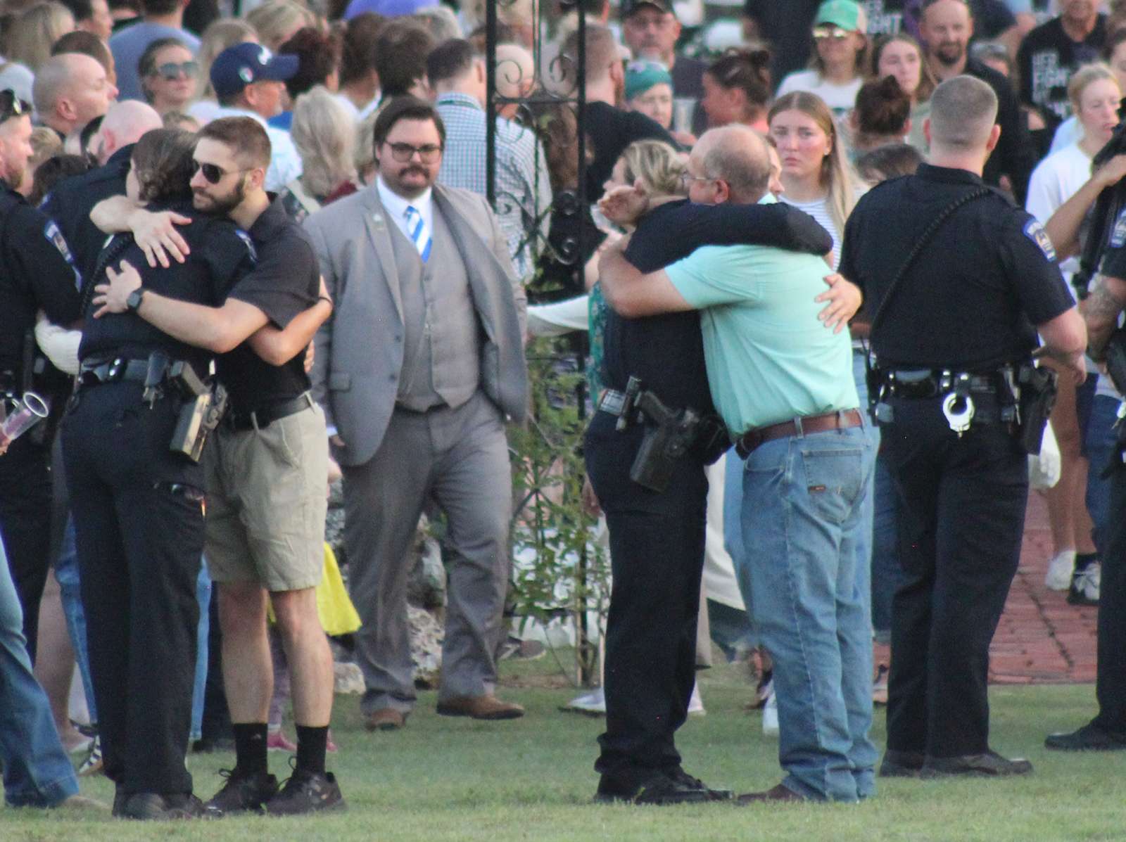 Members of law enforcement are given hugs after the vigil for Sgt. Scott Heimanm, who was killed in the line of duty on Sunday. Photo by Cristina Janney Hays Post