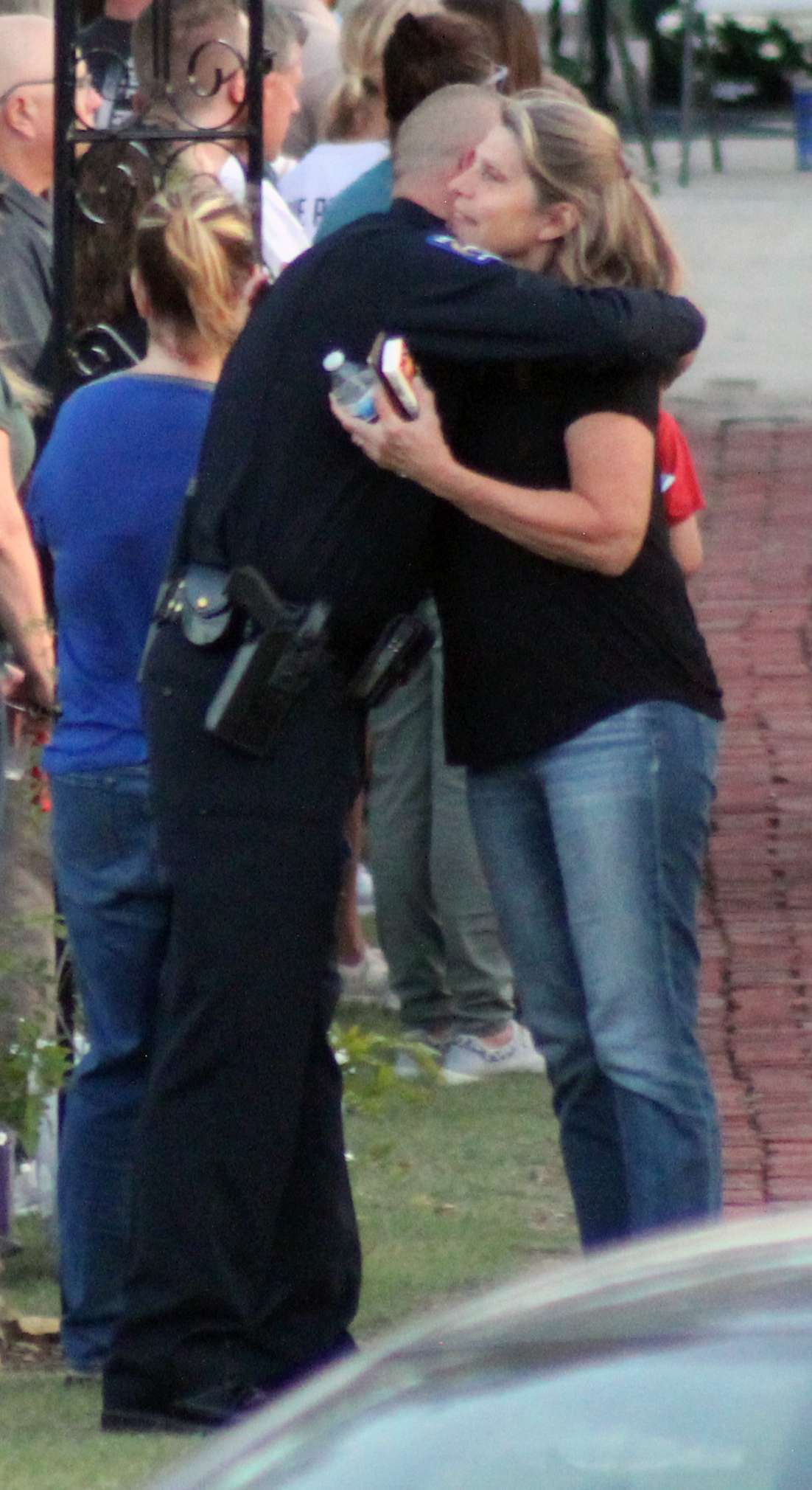 Hays Police Chief Don Scheibler receives a hug after the vigil for Sgt. Scott Heimann, who was killed in the line of duty on Sunday. Photo by Cristina Janney/Hays Post