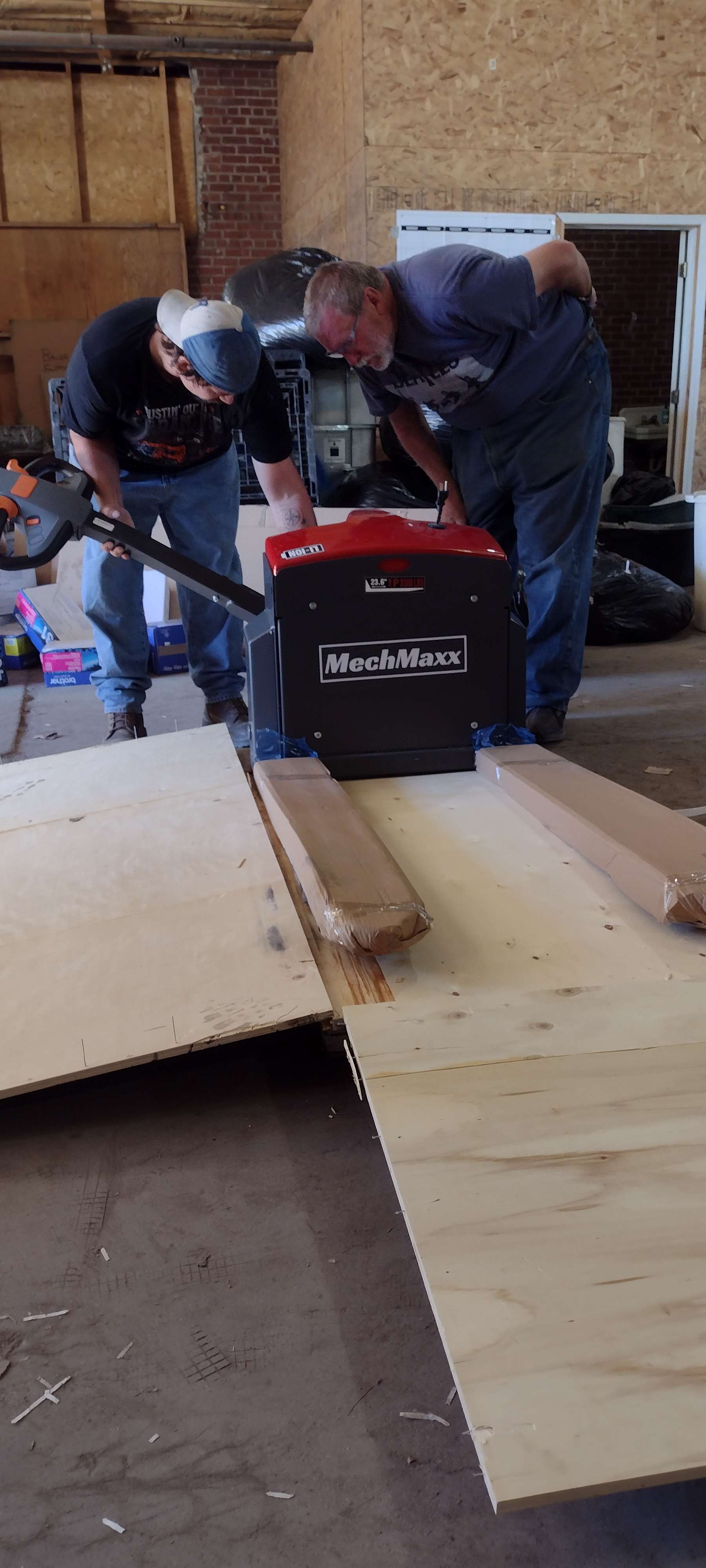 Josh Smith, left, and Tony Fritzler assemble a pallet jack at the KAB Recycling Center.
