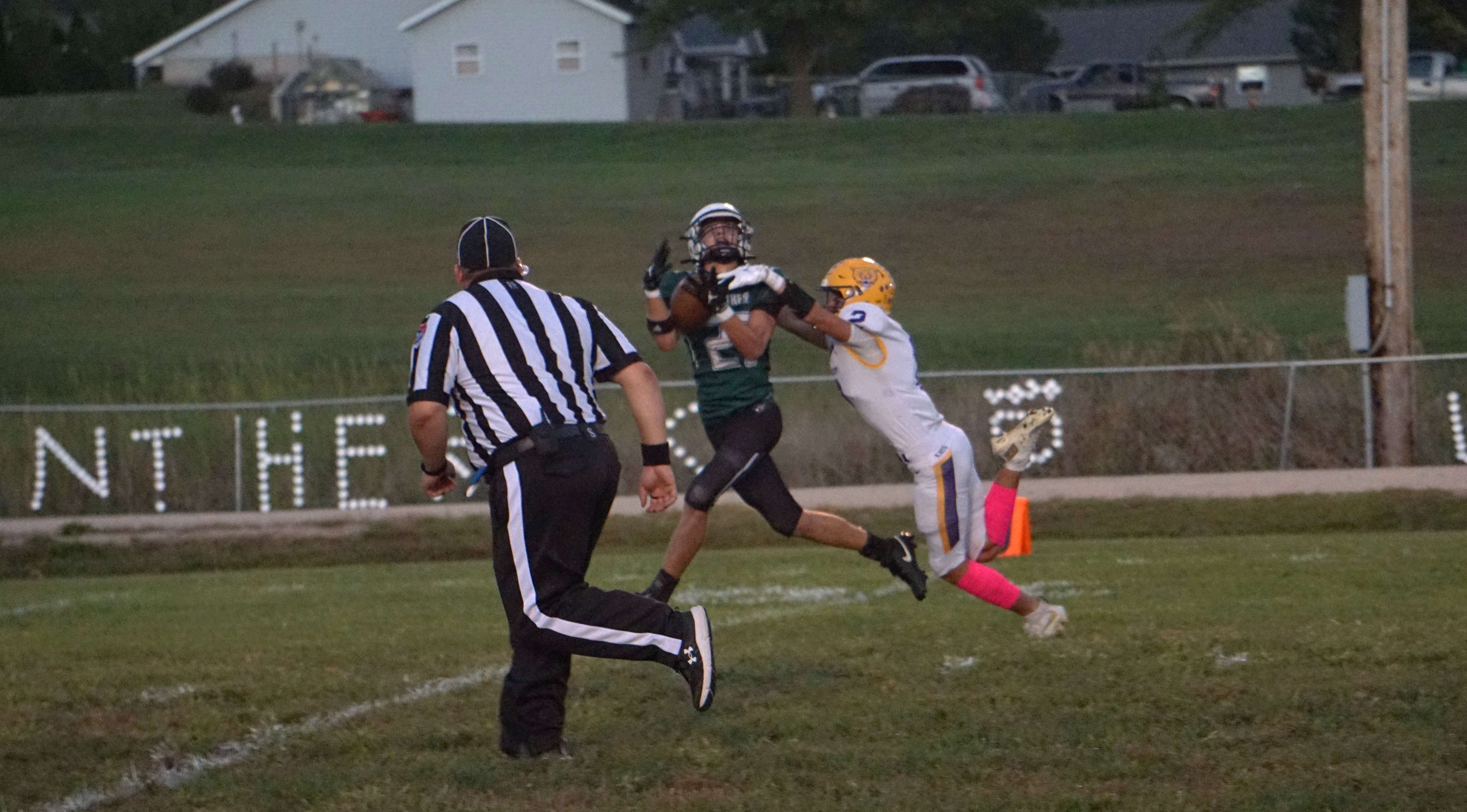Gavin Humphrey (27) makes a contested catch for a touchdown against Ryder Sample (2)/ Photo by Matt Pike