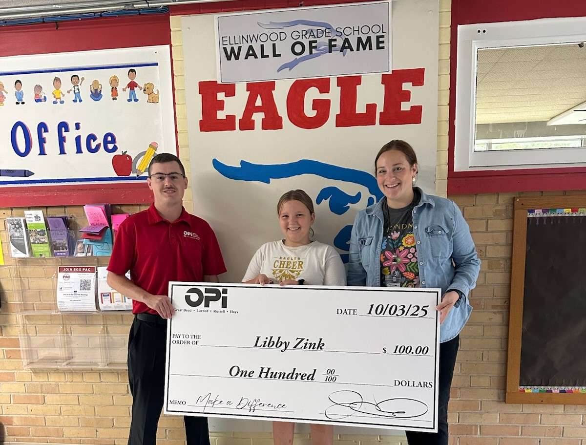Riley from OPI in Great bend presents Ellinwood fifth-grader Libby Zink with a $100 check for being named the final September weekly winner in Eagle Media's Make a Difference Contest. Zink is pictured with school counselor Andrea Birzer.