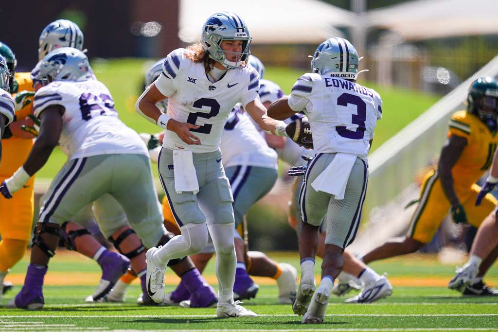 Kansas State quarterback Avery Johnson (2) hands off the ball to Kansas State running back Dylan Edwards (3) during the second half of an NCAA college football game against Baylor, Saturday, Oct. 4, 2025, in Waco, Texas. (AP Photo/Ronaldo Bolaños)