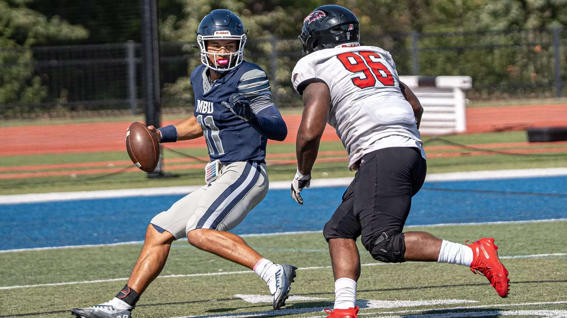Benedictine defensive tackle Kevin Harris chases down Missouri Baptist quarterback Jacob Jones during the Ravens 52-21 victory on Saturday/ Photo courtesy of Missouri Baptist Athletics