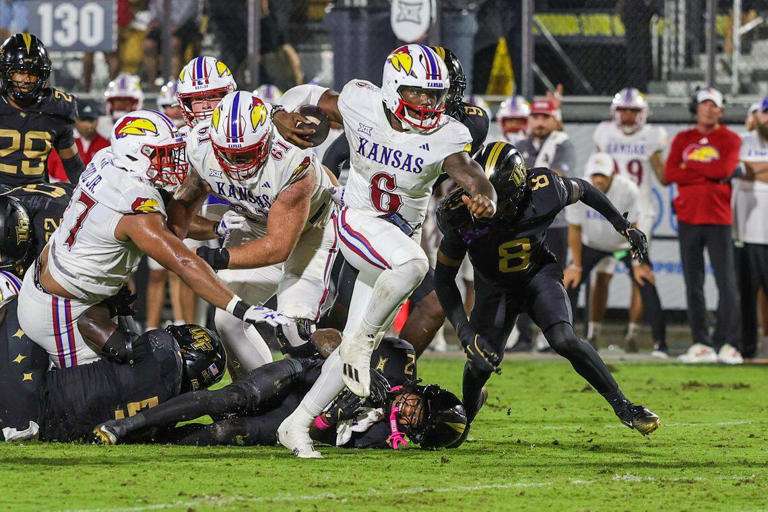Kansas Jayhawks quarterback Jalon Daniels (6) carries the ball during the second quarter against the UCF Knights at the Ascrisure Bounce House on Oct. 4, 2025.