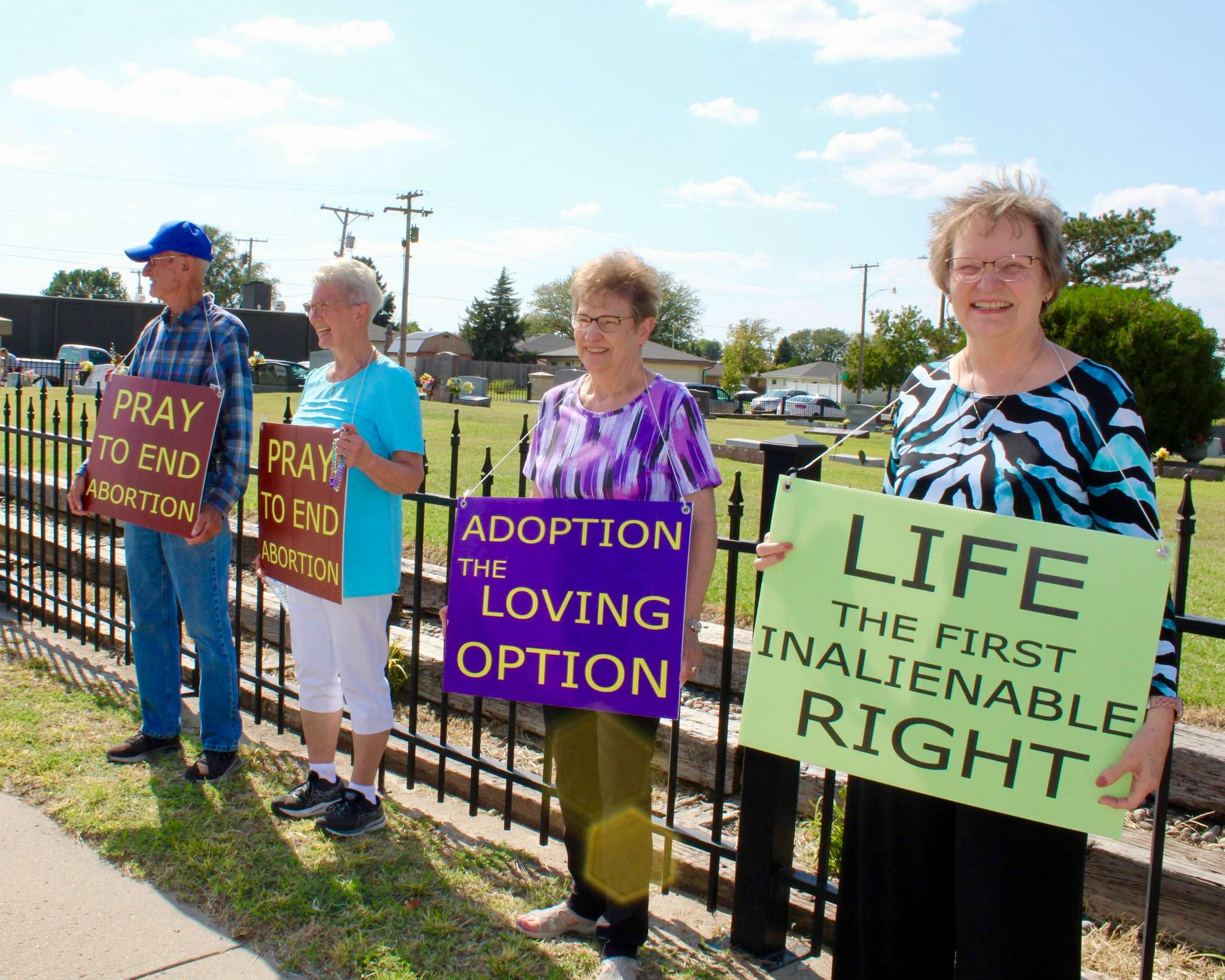 Hays residents holding pro-life signs on Vine Street for the 2025 National Life Chain. Photo by Tony Guerrero/Hays Post