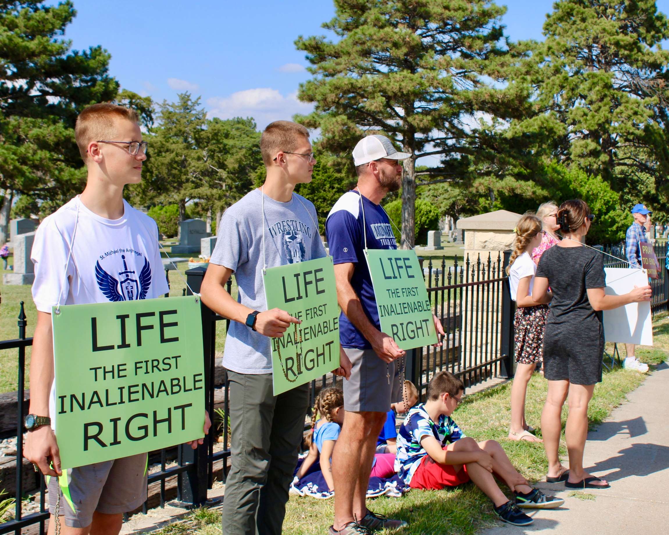 Hays residents holding pro-life signs on Vine Street for the 2025 National Life Chain. Photo by Tony Guerrero/Hays Post