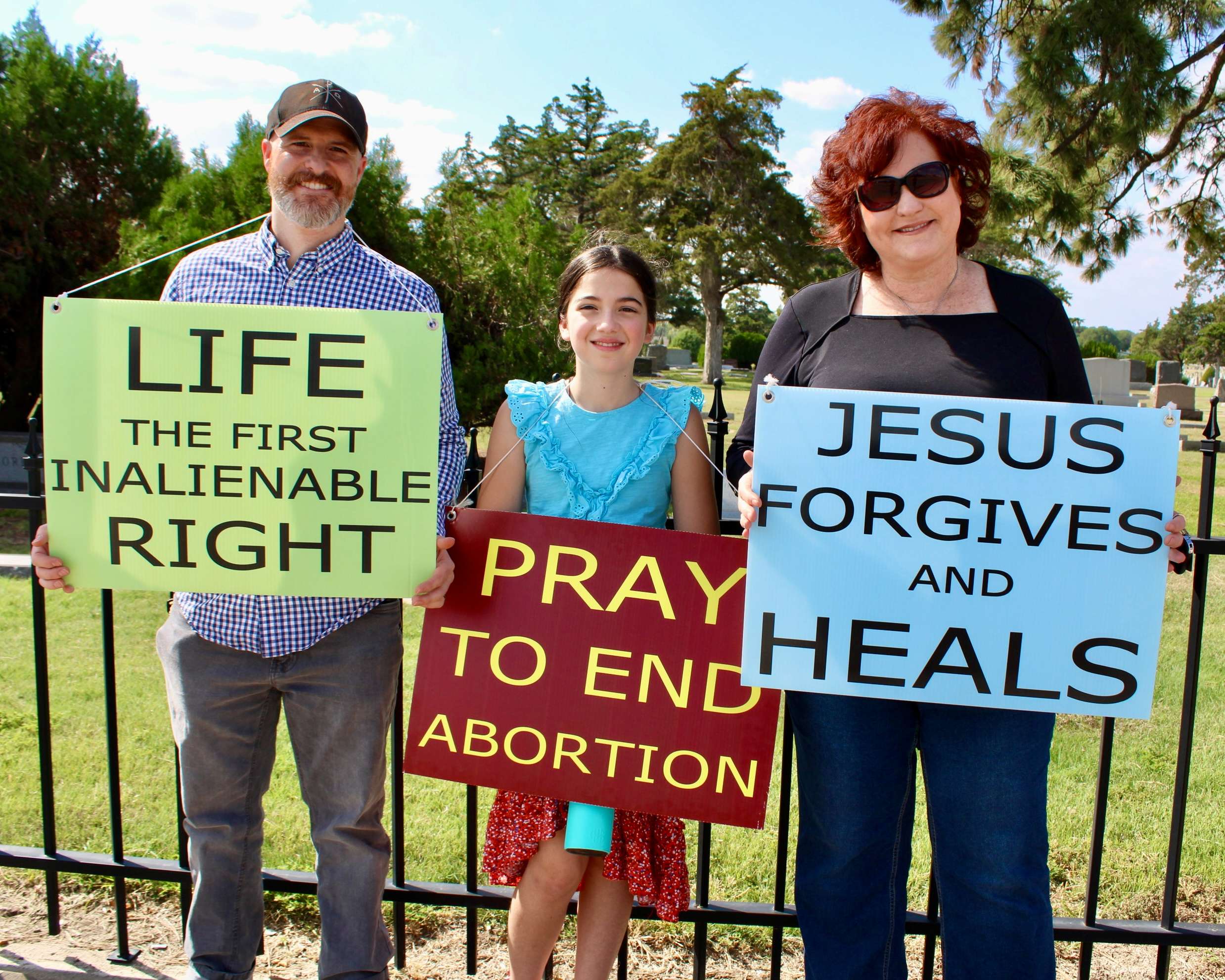 Hays residents holding pro-life signs on Vine Street for the 2025 National Life Chain. Photo by Tony Guerrero/Hays Post