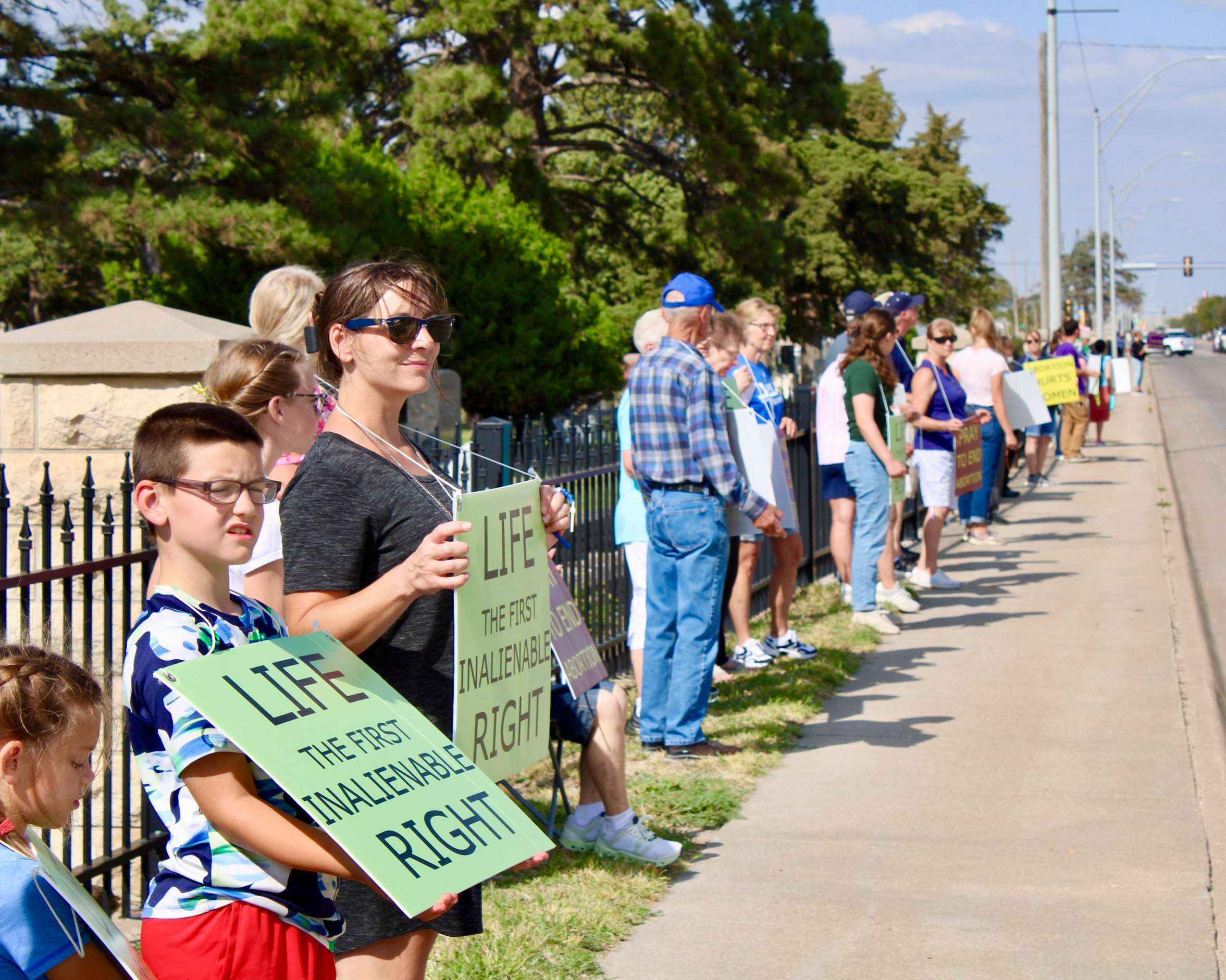 Attendees lined up with pro-life signs on Vine Street for the 2025 National Life Chain. Photo by Tony Guerrero/Hays Post