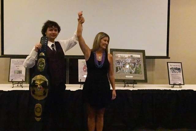 Rhys Froetschner, left, congratulates Lindsay Coombs, winner of the Rock, Paper, Scissors contest at the Sunflower Diversified Services Charity Gala Sept. 13 at the Great Bend Events Center. Froetschner is a staff member at Sunflower Recycling; Coombs won a Championship Belt and bragging rights.