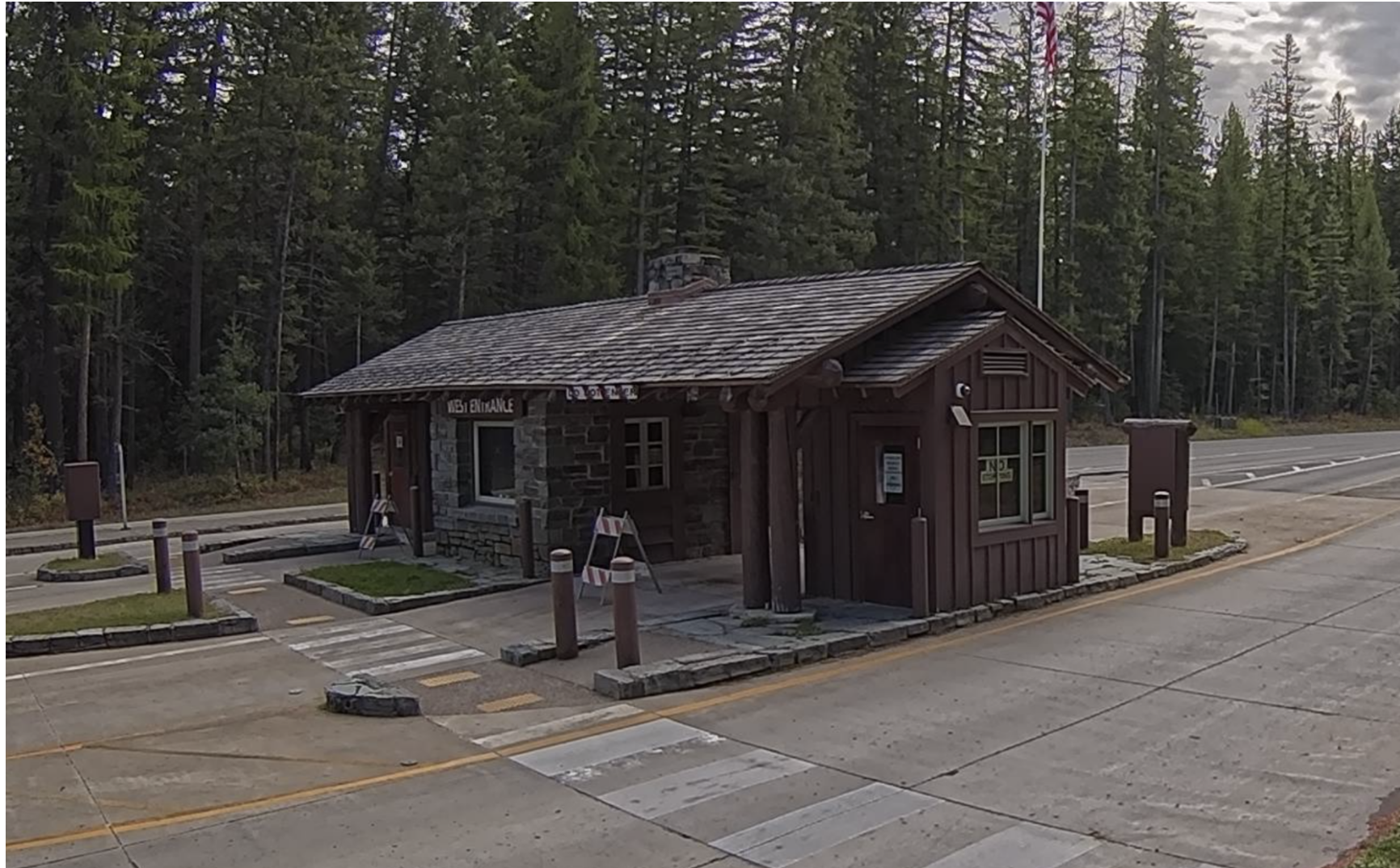 A webcam image of the entrance station to Glacier National Park shows blocked off lanes and shuttered windows on Oct. 3, 2025.