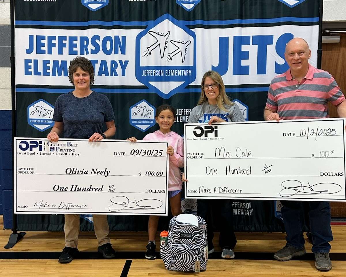 OPI's Tina Koochel and Alan Soukup present Jefferson third grader Olivia Neely and her teacher, Mrs. Cale, with giant $100 checks after Neely was selected Make a Difference winner for the month of September.