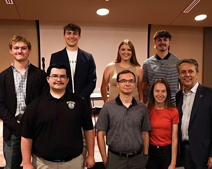 Tyler Preisser, president of Fort Hays State University Turning Point USA (back second from the left), and other members of the chapter, Micky Mason of FHSU College Republicans (front left) and Former Gov. Jeff Colyer. Courtesy photo