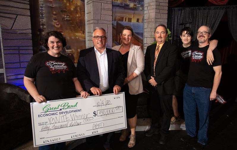 Allie Cartwright, owner of Freaking Delicious Cheesecake Company, celebrates her $50,000 grand prize with IGNITE Rural Business Competition judges Chad Somers, Sara Bloom, Mike Johnson, and her family. (photo by Brandon Steinert)