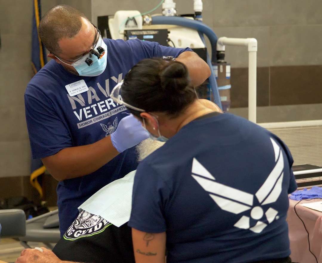 A patient at the 3rd annual Veterans Mission of Mercy Dental Event receives care from Navy and Air Force veterans. Several of the dentists, dental hygienists, and other volunteers at the event were veterans themselves.