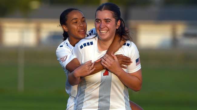 Ona Dowling Perdomo is congratulated by teammate Beatrice Salas after scoring her first career goal in the Blue Dragon women's soccer team's 8-1 win over Dodge City on Friday at the Salthawk Soccer Complex. (Steve Carpenter/Blue Dragon Sports Information)