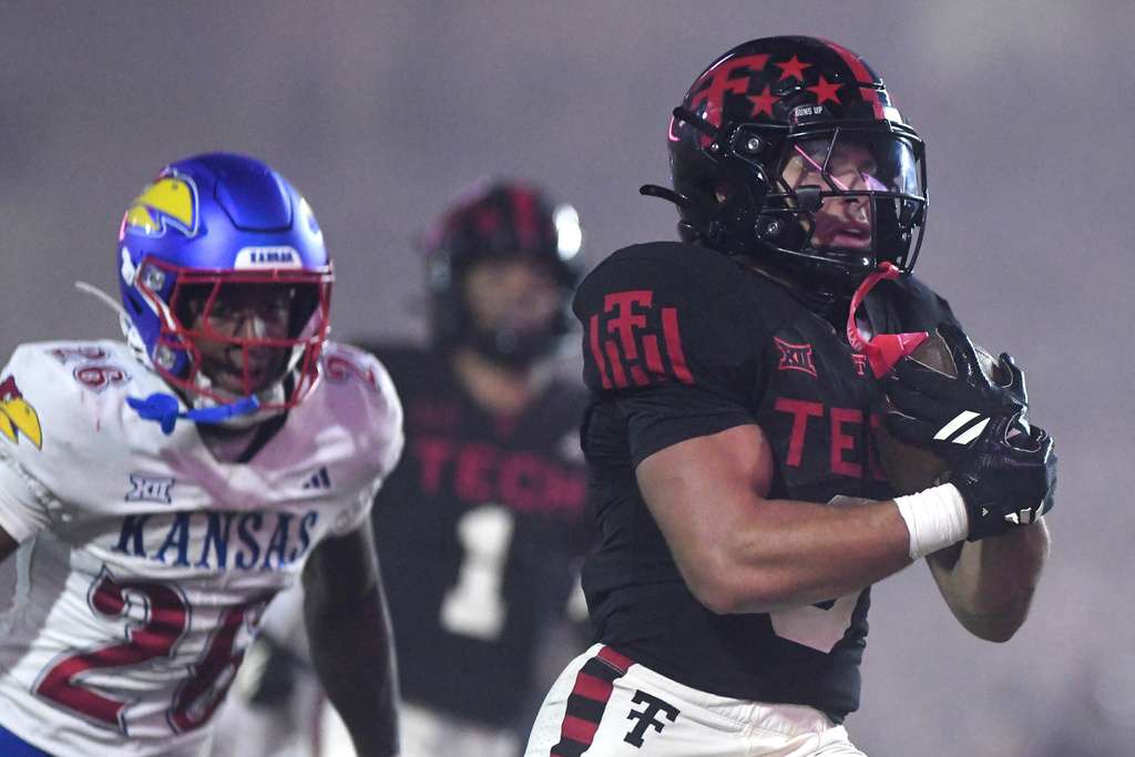 Texas Tech running back Cameron Dickey (8) runs into the end zone for a touchdown during the fourth quarter of an NCAA college football game, Saturday, Oct. 11, 2025, in Lubbock, Texas. (AP Photo/Annie Rice)