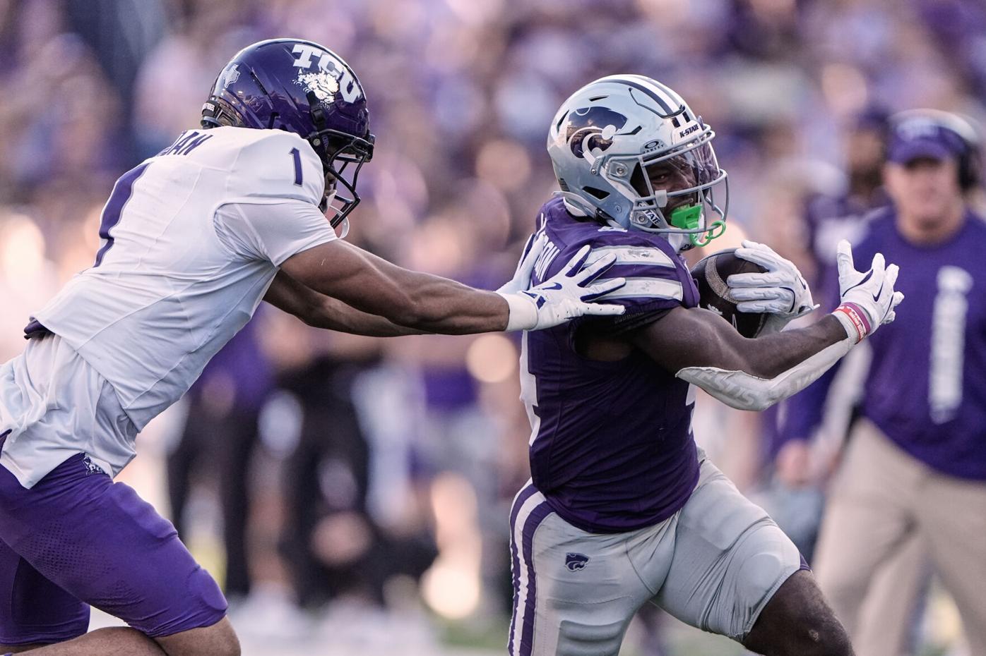 Kansas State running back Joe Jackson, right, is pushed out of bounds by TCU safety Austin Jordan (1) as he runs the ball for a first down during the second half of an NCAA college football game against TCU, Saturday, Oct. 11, 2025, in Manhattan, Kan. (AP Photo/Charlie Riedel)
