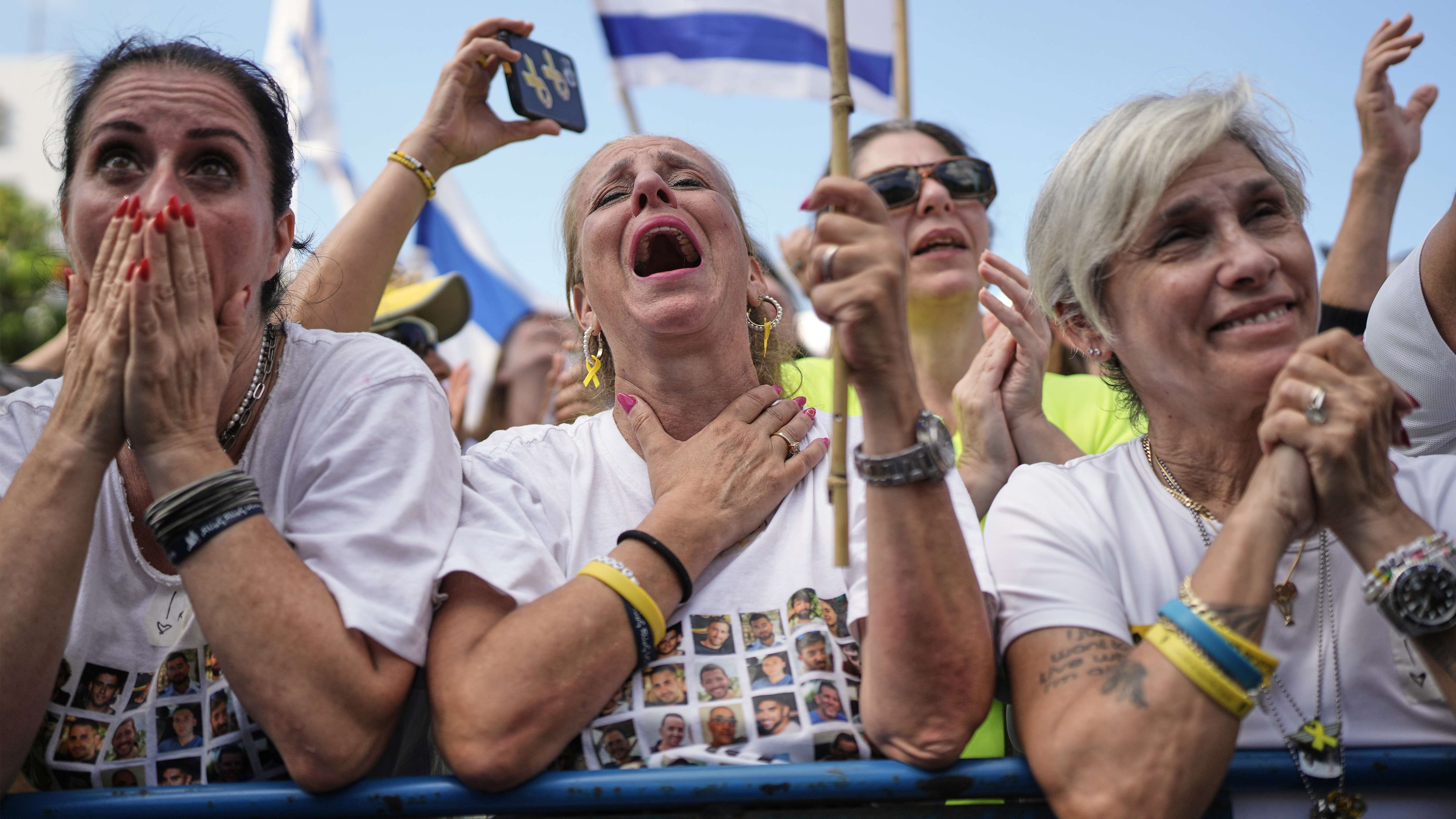 People react as they gather to watch a live broadcast of Israeli hostages released from Gaza at a plaza known as hostages square in Tel Aviv, Israel, Monday, Oct. 13, 2025. (Photo by Oded Balilty)