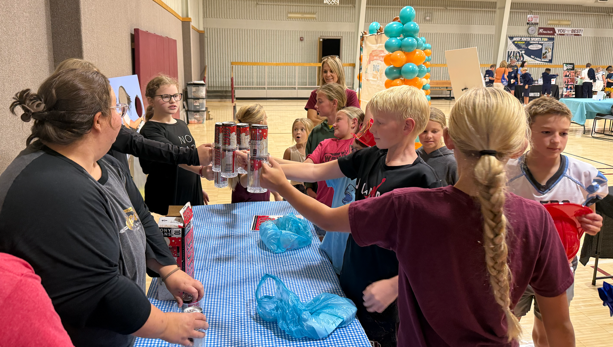 Hays USD 489 participate in a root beer stein holding contest sponsored by Oktoberfest at the Heartland Community Foundation Give Fest on Friday.&nbsp;Photo by Cristina Janney/Hays Post