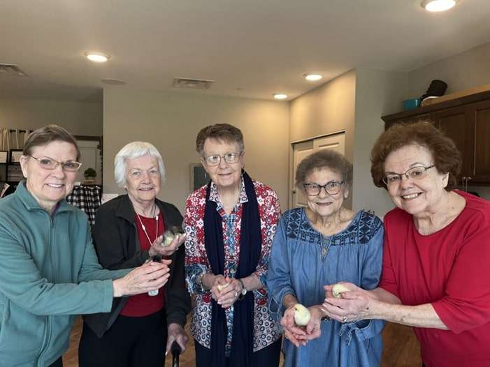 Cedarhurst residents holding newly hatched chicks. Courtesy of Cedarhurst Senior Living.
