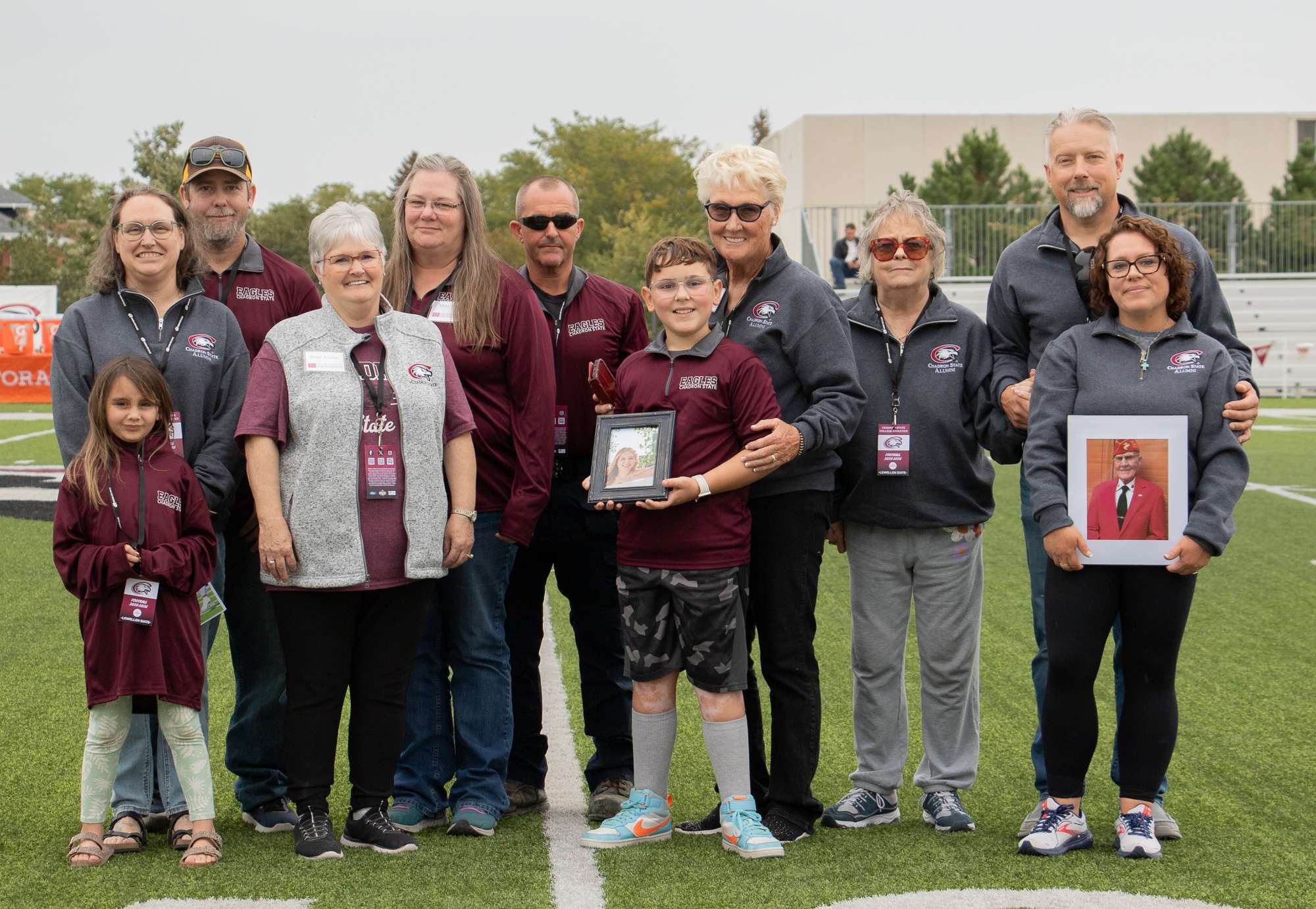 The Owens family is honored with the Family Tree Award Oct. 11, 2025, during halftime of the football game. From left, Vyolet Hileman, Jamie (Clyde) Hileman, Tate Hileman, Milinda (Owens) Wineteer, Milisa (Owens) Palmer, Rick Palmer, Riley Owens, Dr. JoAnne Owens-Nauslar, Kristy (Heppner) Owens, Heath Owens, and Brooke (Shimp) Owens. (Photo by Tena L. Cook/Chadron State College)