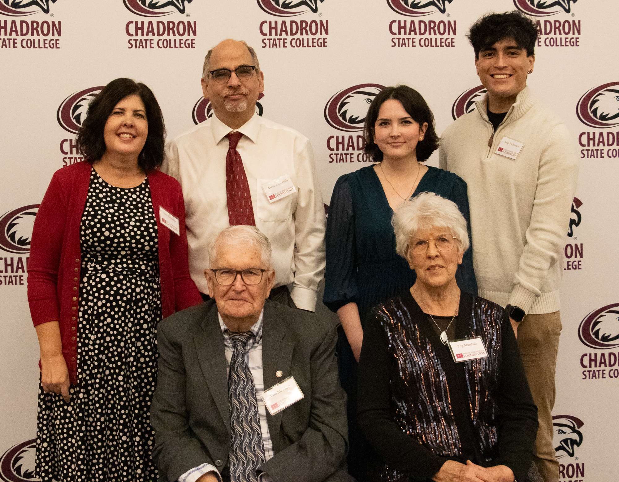 The Marshall family is honored with the Family Tree Award on Oct. 10, 2025, during the Chadron State Foundation Board Annual Meeting in the Student Center. Back row, from left, Sara and Aaron Behrends, and Olivia and Angel Veladez. Seated, from left, Con Marshall and Peggy Marshall. (Photo by Tena L. Cook/Chadron State College)