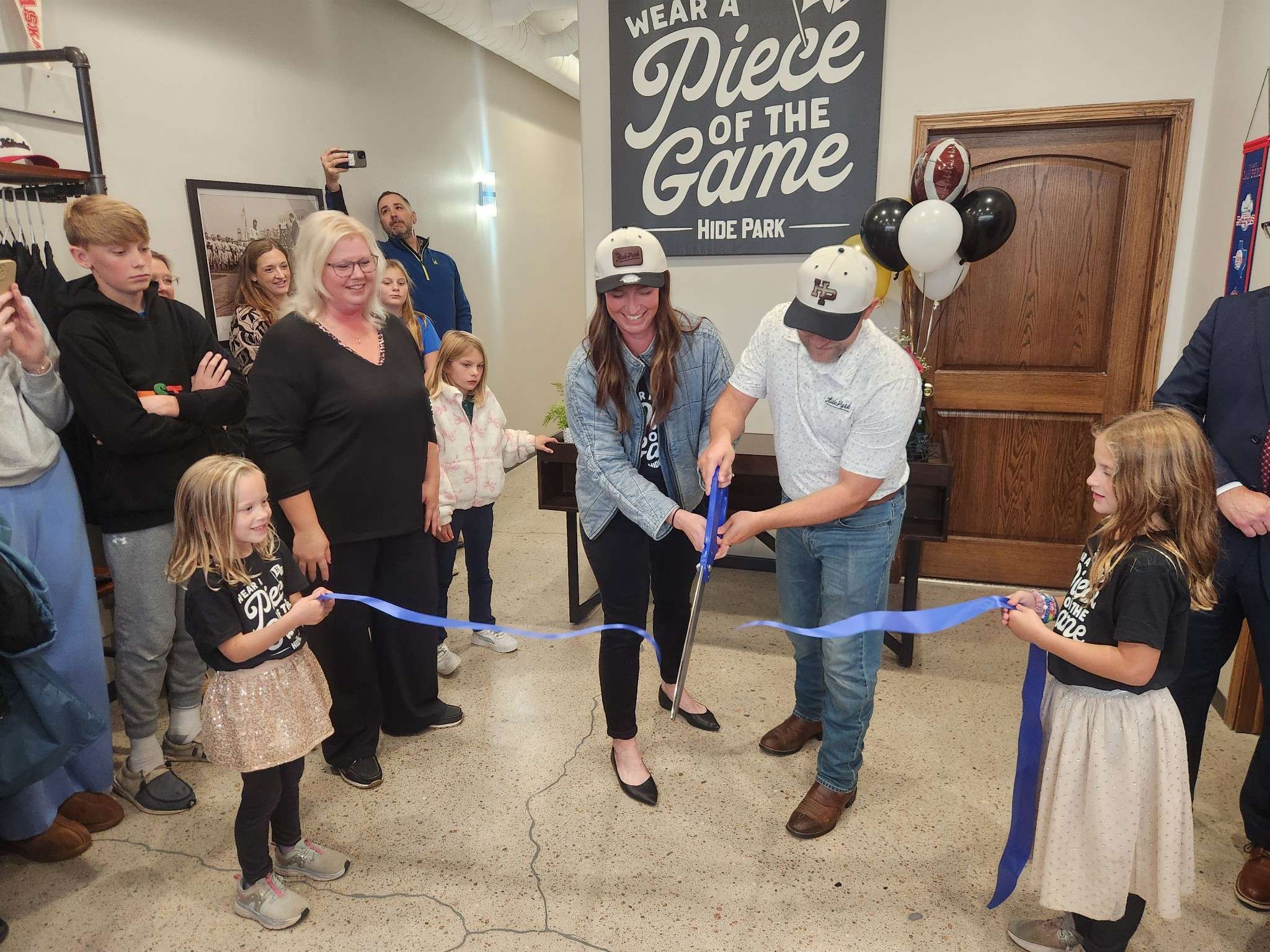 The Sperle family sport their Hide Park Apparel hats at the Ribbon Cutting October 14. (Photo Courtesy North Platte Chamber & Development)