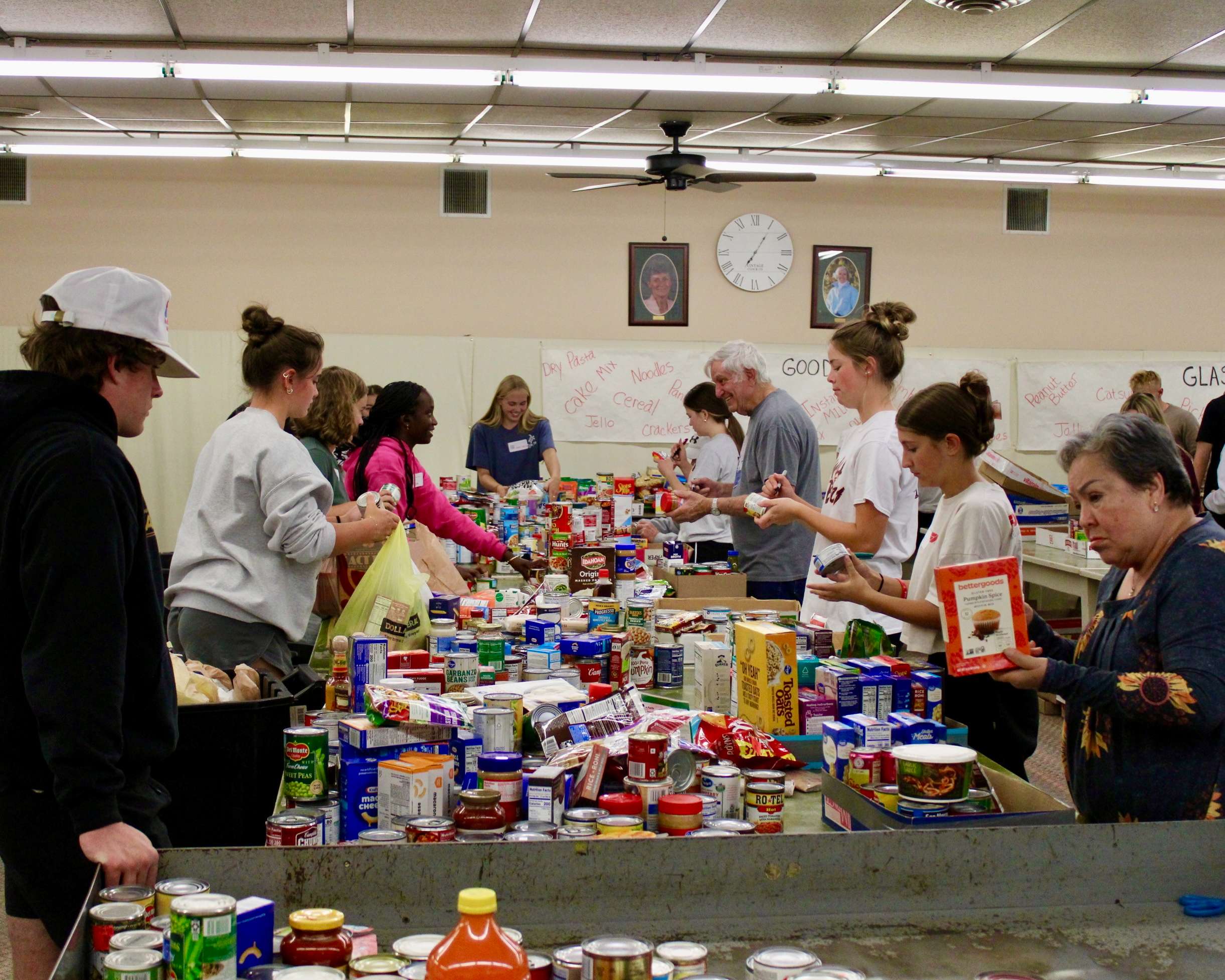 Volunteers counting and organizing food items at the Community Assistance Center in Hays for Trick or Treat So Others Can Eat. Photo by Tony Guerrero/Hays Post
