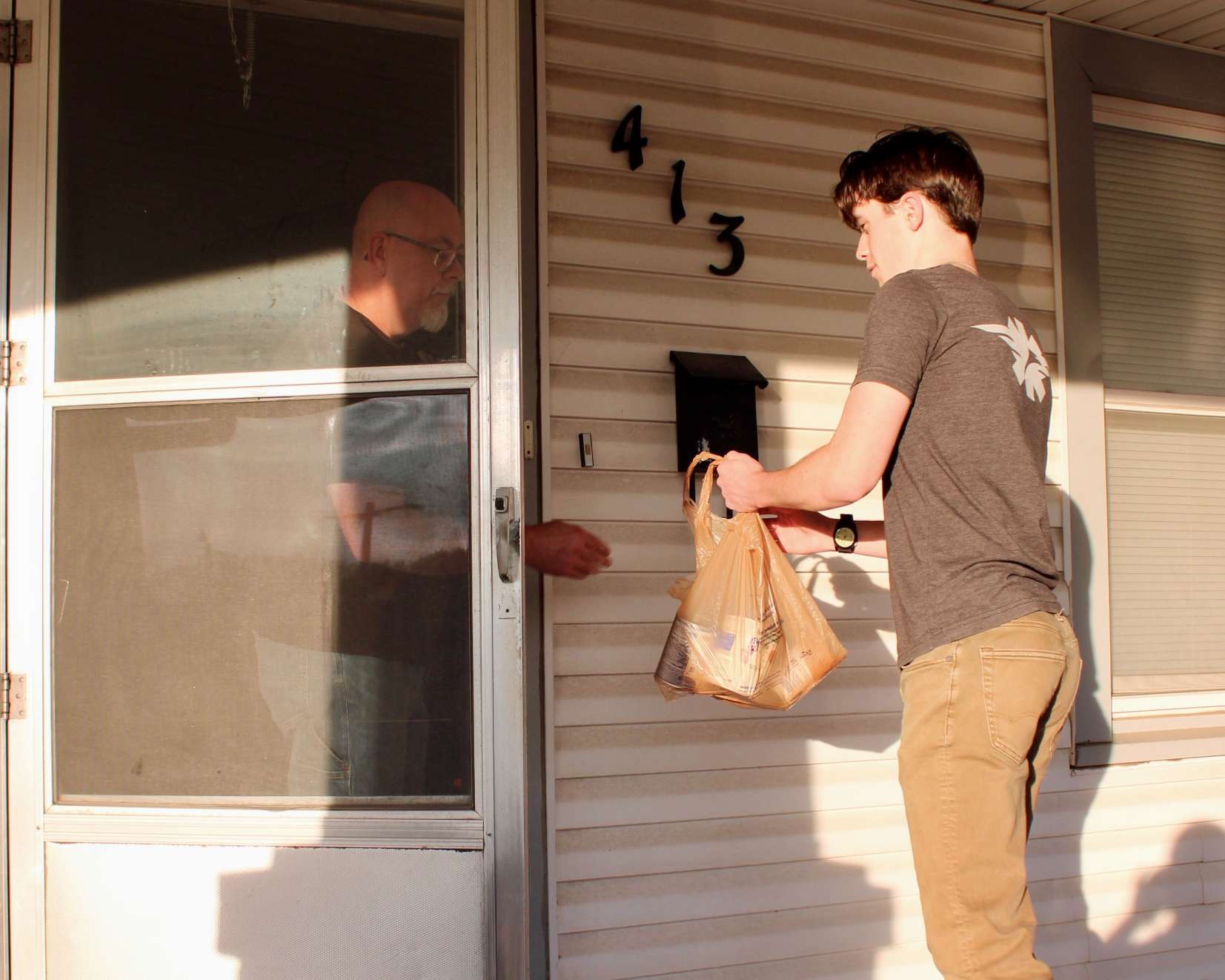 A volunteer collecting food items for Trick or Treat So Others Can Eat in Hays. Photo by Tony Guerrero/Hays Post