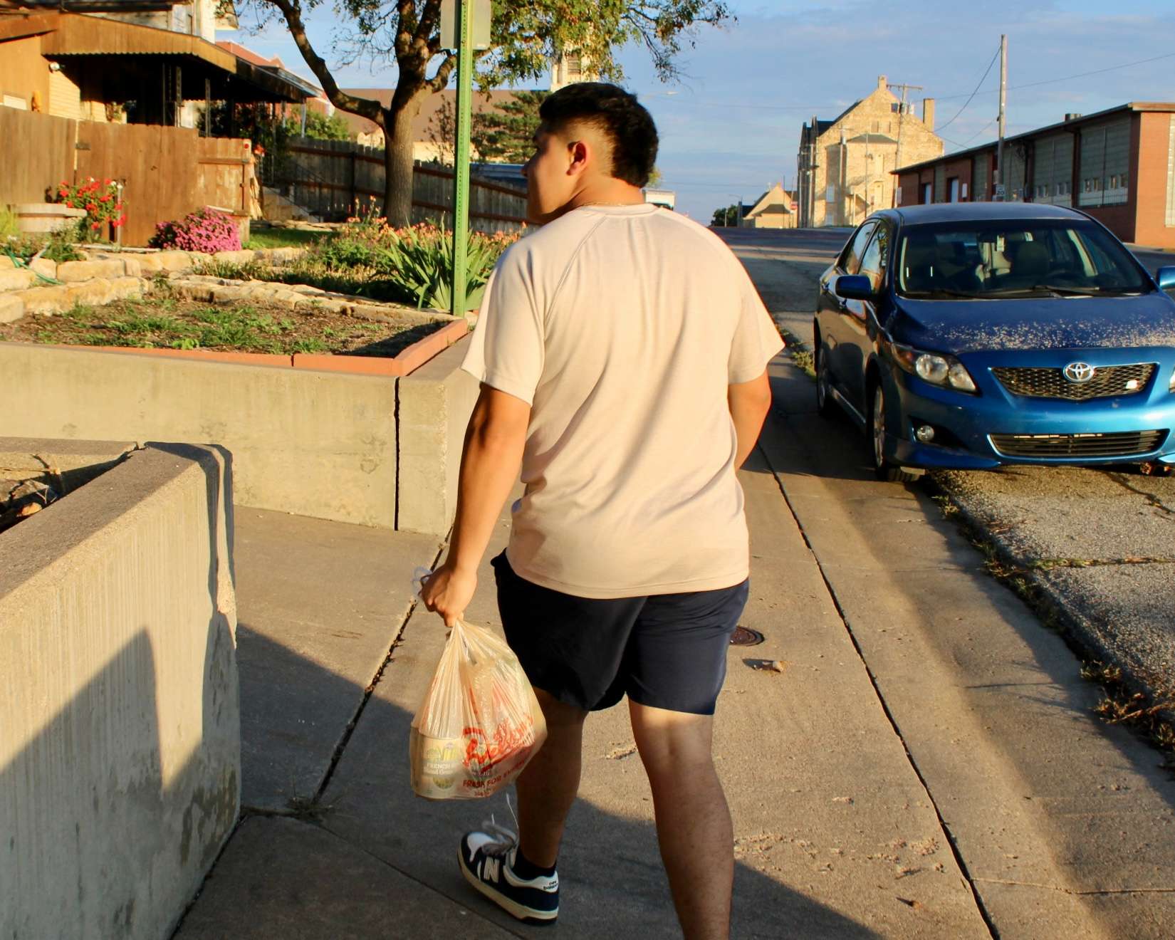 A volunteer with a bag of food for Trick or Treat So Others Can Eat in Hays. Photo by Tony Guerrero/Hays Post