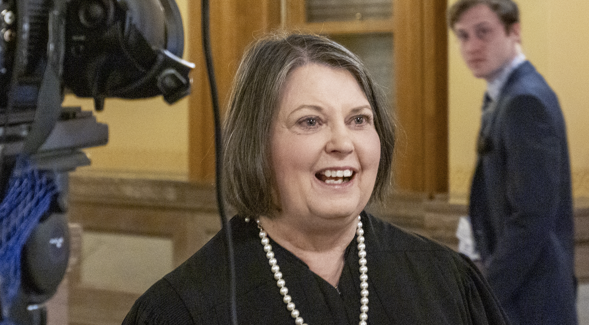 Marla Luckert, chief justice of the Kansas Supreme Court, says she was in a one-car accident on Oct. 9 after likely suffering a stroke. She plans to take several weeks to recuperate. In this Jan. 15, 2025, photo, Luckert talks to reporters after addressing lawmakers at the Statehouse. (Sherman Smith/Kansas Reflector)