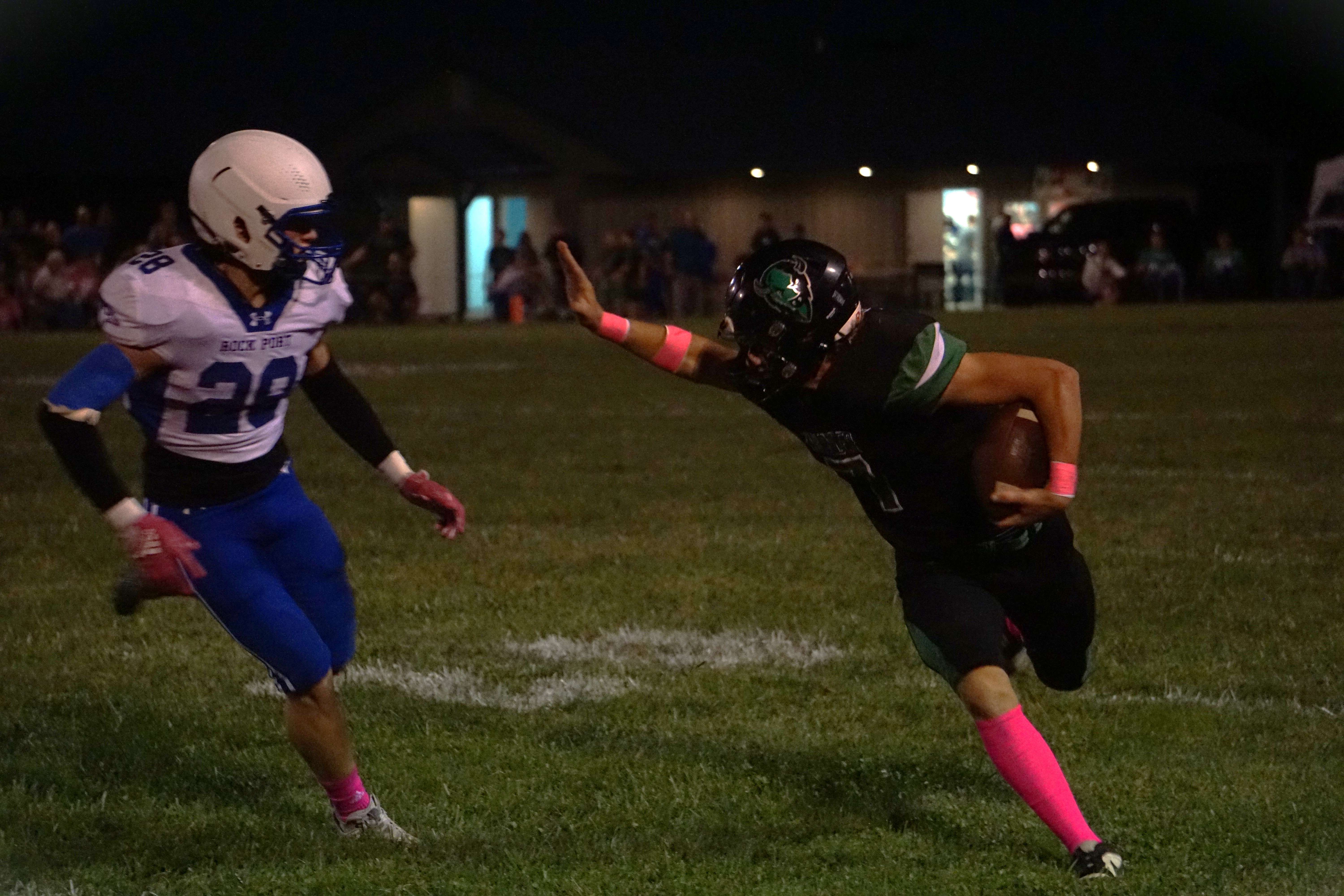 Nodaway Valley's Cooper Snodderly (7) stiff arms Rock Ports Camden McEnaney (28)/ Photo by Matt PIke