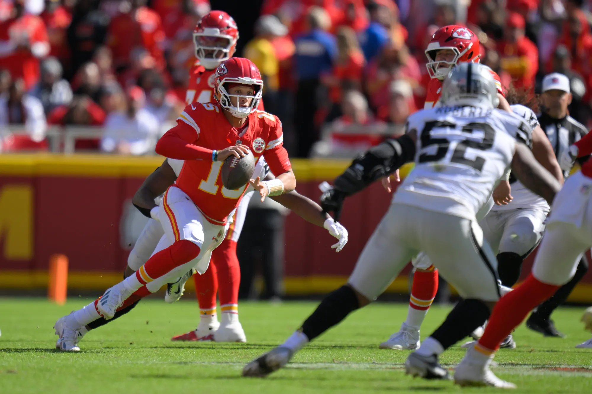 Kansas City Chiefs quarterback Patrick Mahomes scrambles during the first half of an NFL football game against the Las Vegas Raiders Sunday, Oct. 19, 2025, in Kansas City, Mo. (AP Photo/Reed Hoffmann)