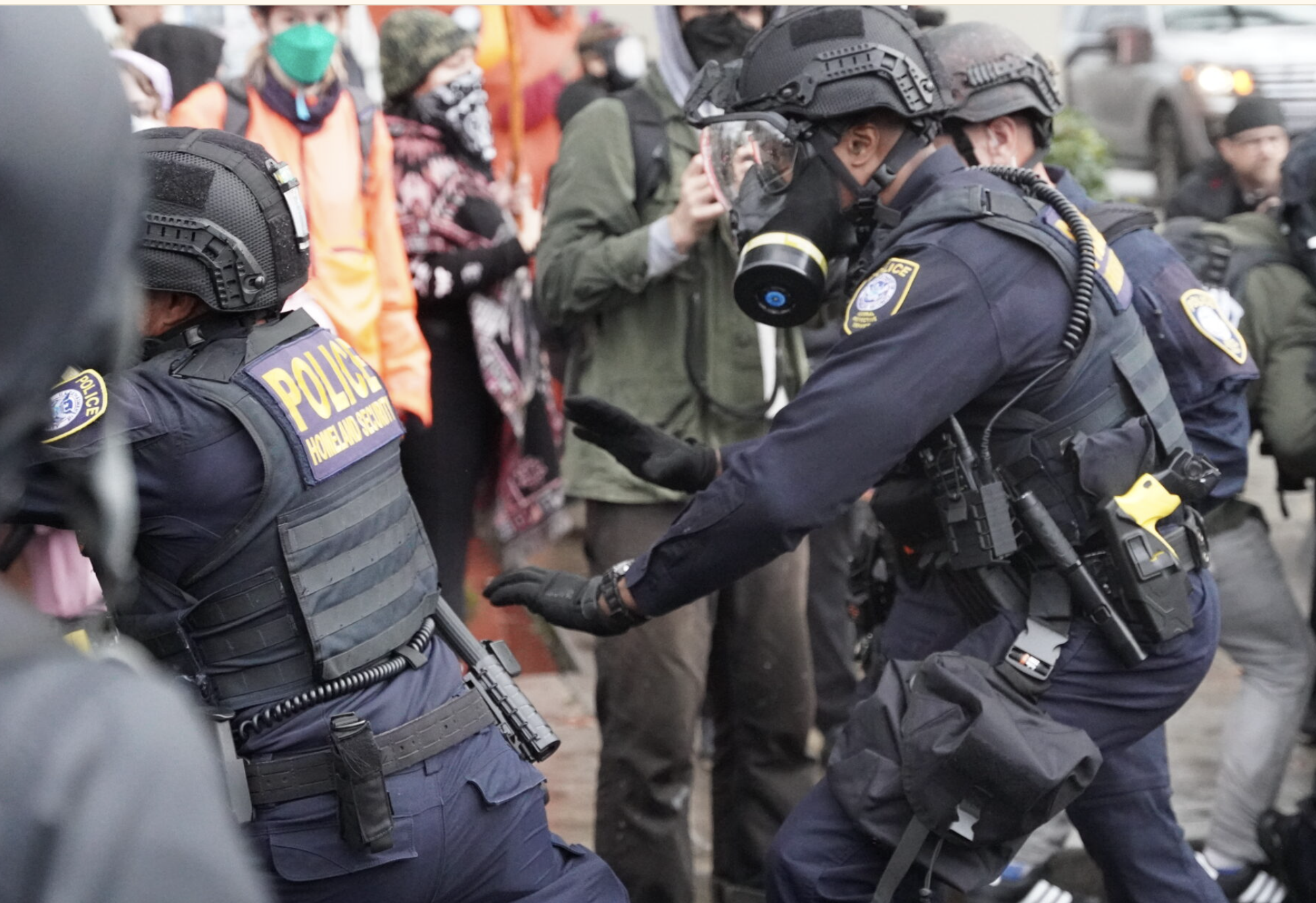  Department of Homeland Security police, along with other federal police, push protestors at the Immigration and Customs Enforcement facility south of downtown Portland on Sunday, Oct. 12, 2025. (Photo by Alex Baumhardt/Oregon Capital Chronicle)