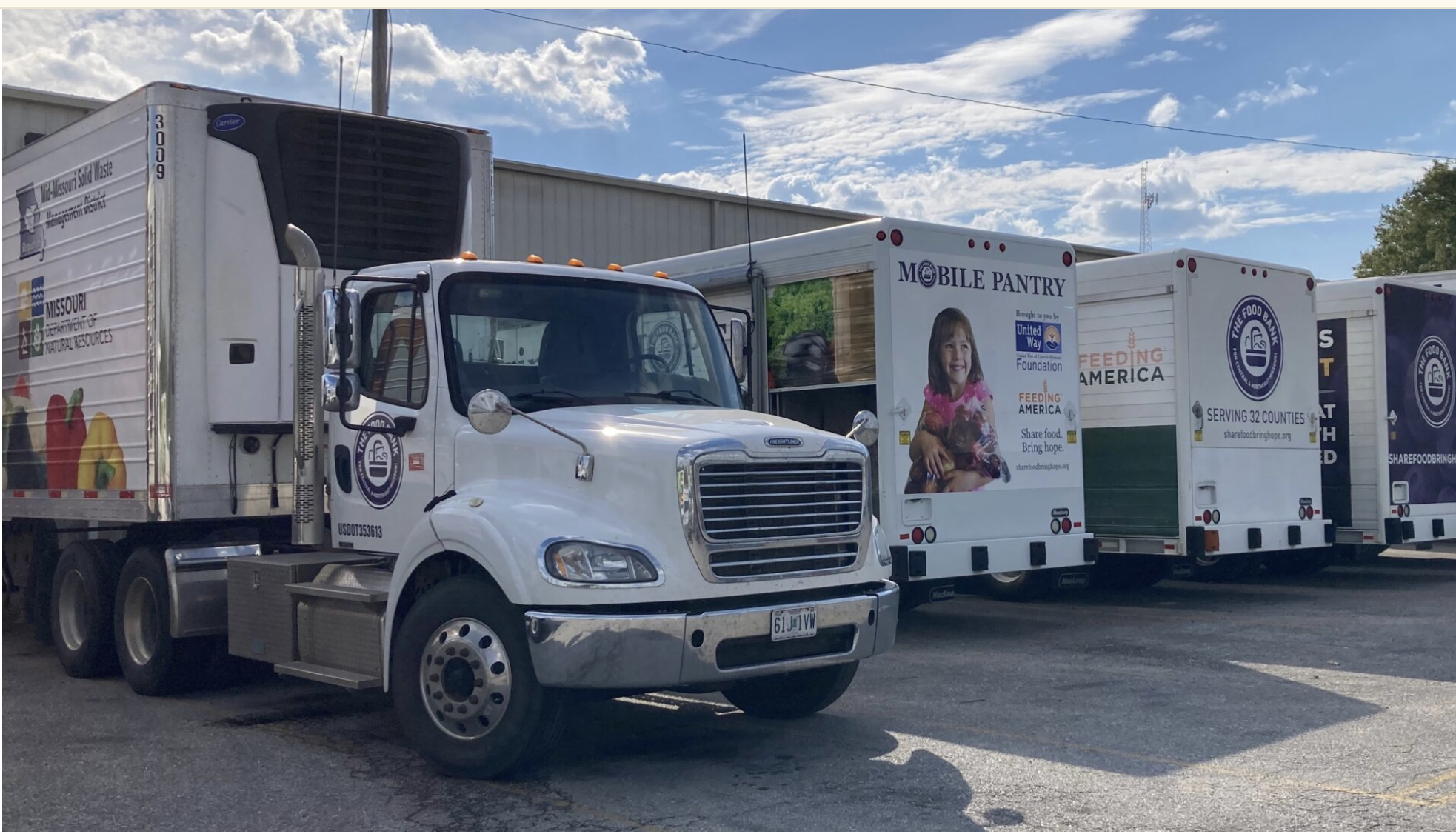Delivery trucks wait in the parking lot of the Food Bank for Central and Northeast Missouri in Columbia, which serves 32 counties, on Oct. 17. (Steph Quinn | Missouri Independent)