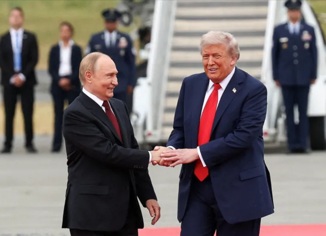 US President Donald Trump shakes hands with Russian leader Vladimir Putin, as they meet to negotiate an end to the war in Ukraine, in Anchorage, Alaska, on August 15, 2025 [Kevin Lamarque/Reuters]