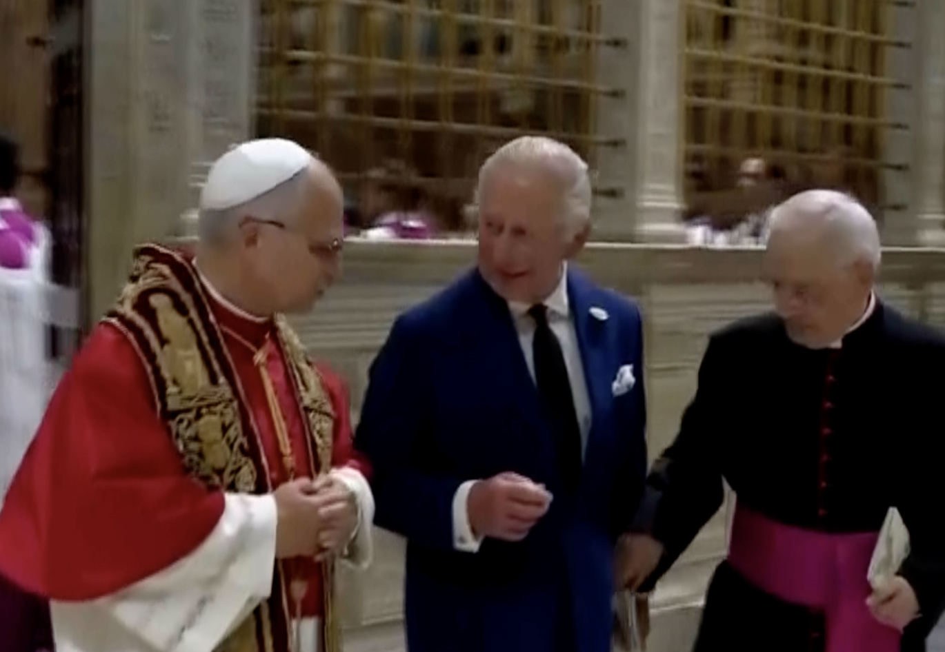 Pope Leo XIV, center, cheers with Britain's King Charles III in the St. Damasus Courtyard at the Vatican after a state visit and pray with him in the Sistine Chapel, Thursday, Oct. 23, 2025. image from Associated Press vide