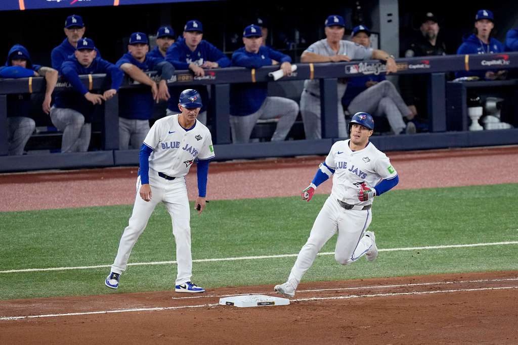 &nbsp;Toronto Blue Jays' Daulton Varsho runs past the Los Angeles Dodgers dugout after hitting his two run home run during the fourth inning in Game 1 of baseball's World Series, Friday, Oct. 24, 2025, in Toronto. (AP Photo/David J. Phillip)