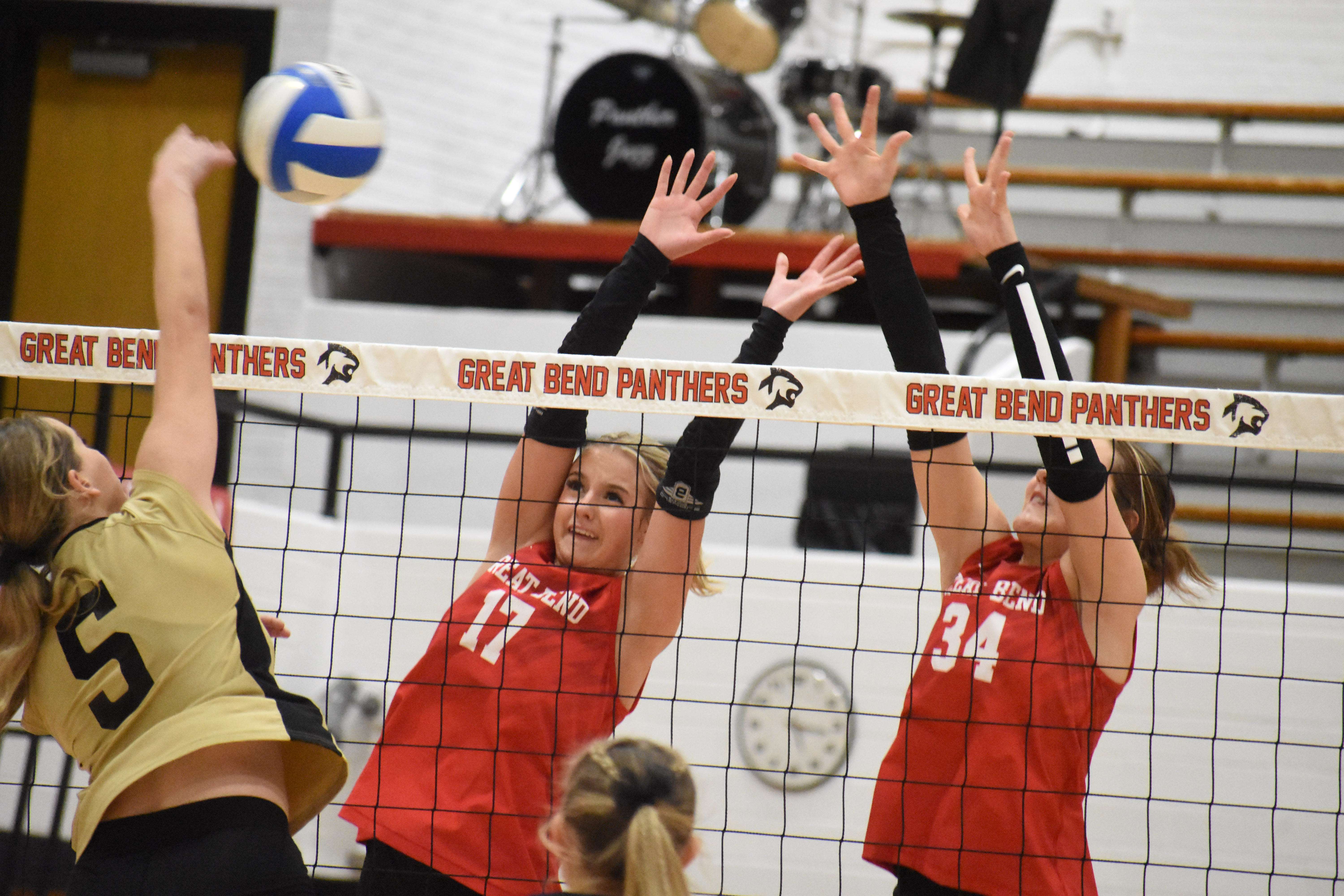 Great Bend's Kya Behr (17) and Stevie Mayers (34) go up for a block against Andover Central's Madelyn Jacobs.