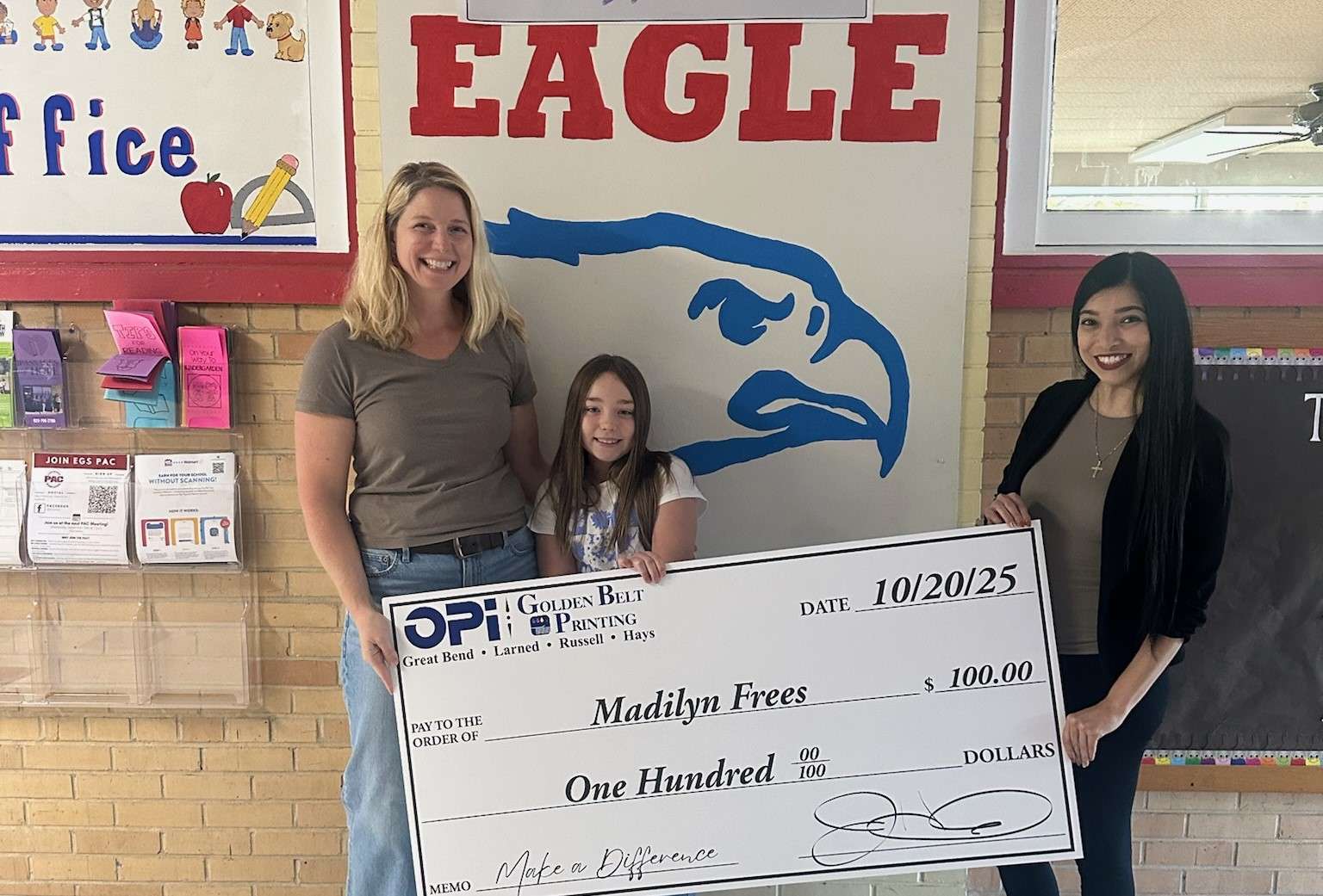 OPI's Bertha presented Ellinwood fourth grader Madilyn Frees with a giant $100 check after Frees was selected as a weekly winner in the Make a Difference Contest. Frees is a student in Terra Ricker's class.