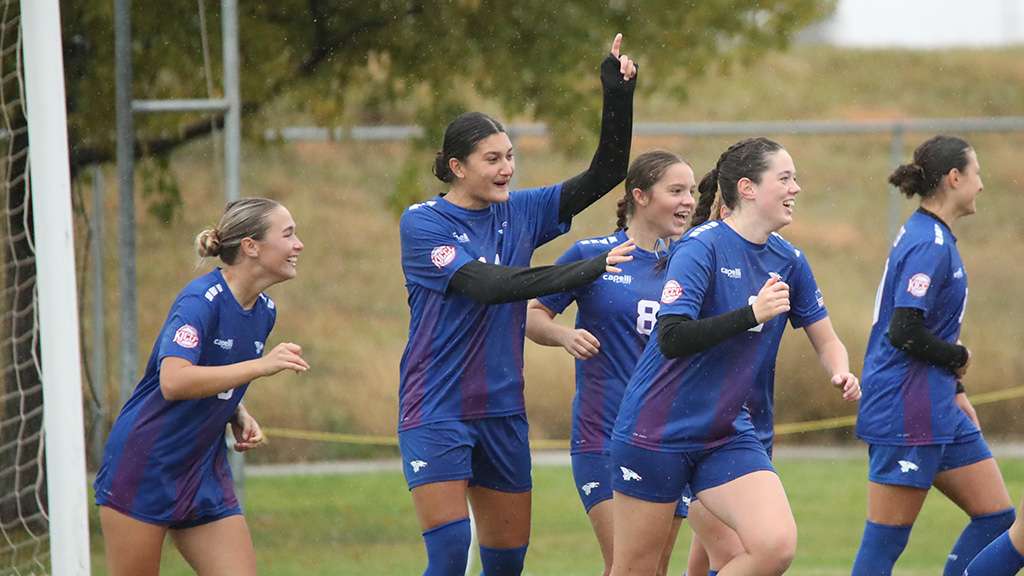 Lucy Bacon (2) celebrates scoring the Blue Dragons' first goal as No. 19 Hutchinson tied Barton 2-2 on Saturday in Great Bend. (Photo by Todd Moore/Barton Sports Information)
