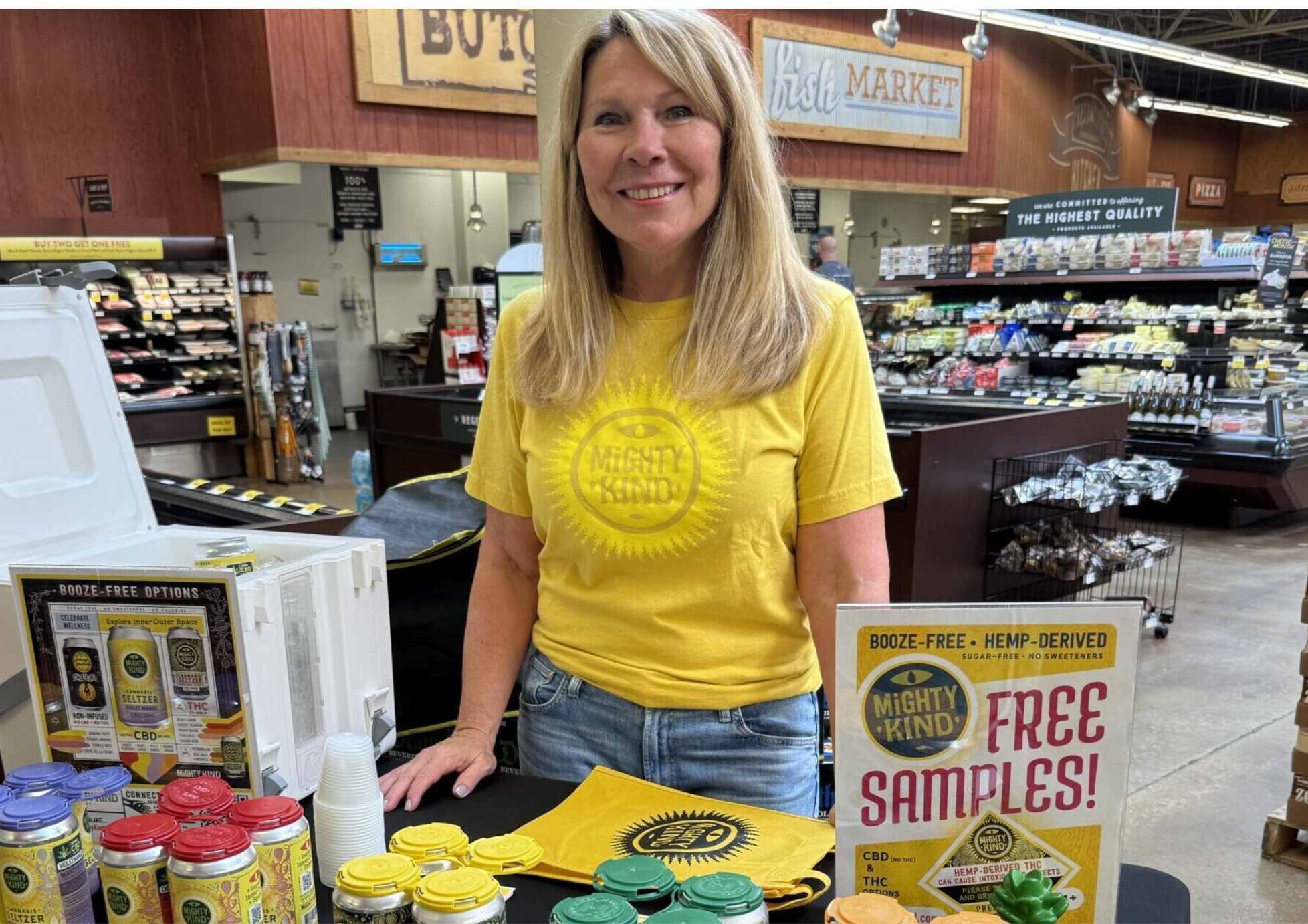 Karen Brady, the mother of Mighty Kind owner Josh Grigaitis, waits to talk to shoppers at Fresh Thyme grocery store in St. Louis about the company’s hemp THC seltzers (photo submitted).